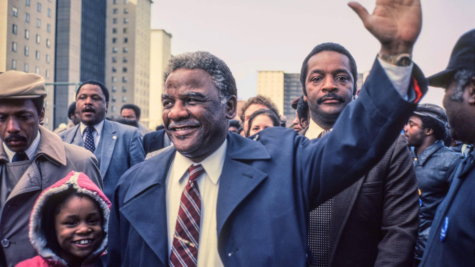 Photo of a man waving to a crowd. 