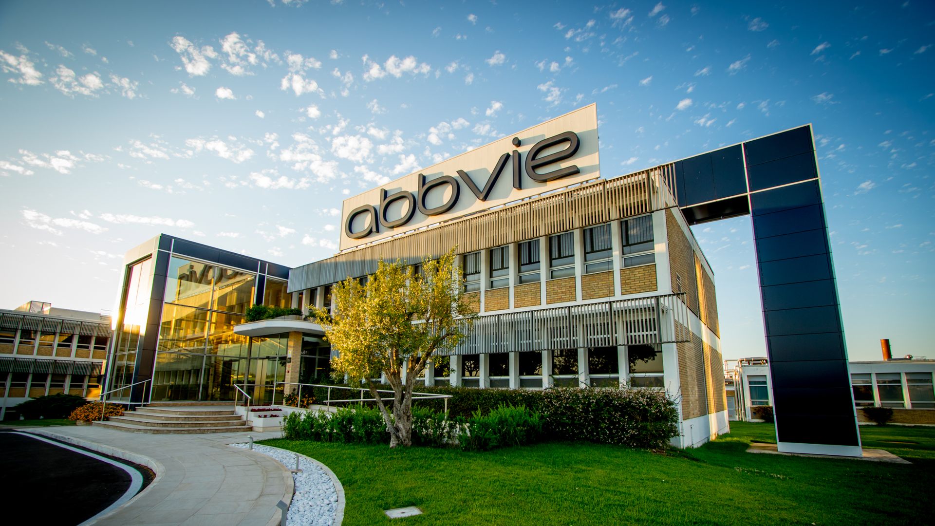 A manufacturing plant with the blue AbbVie logo on top.