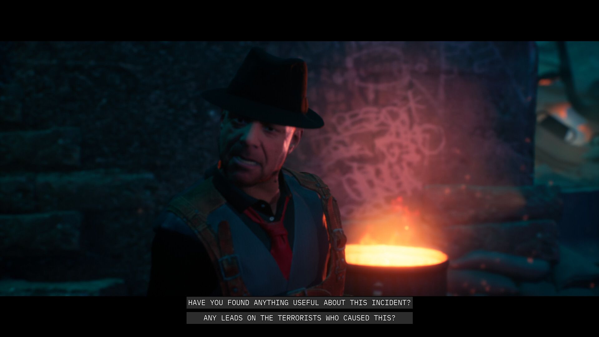 Video game screenshot of a man in a fedora. Subtitles show him asking about whether the player has found the terrorists responsible for an explosion.