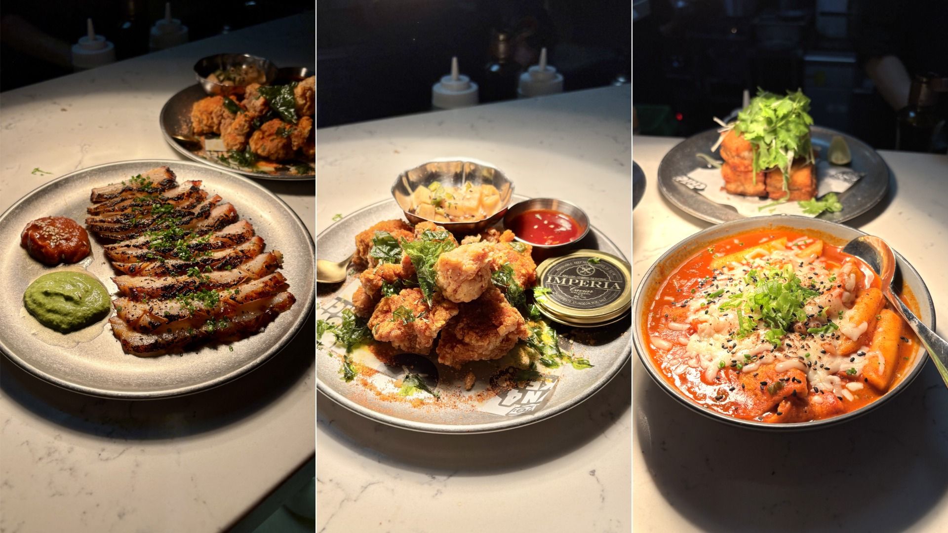Three plates of food: grilled sliced meat with two sauces, fried chicken with herbs and dipping sauces, and a spicy red stew with rice cakes and cheese, garnished with green onions.