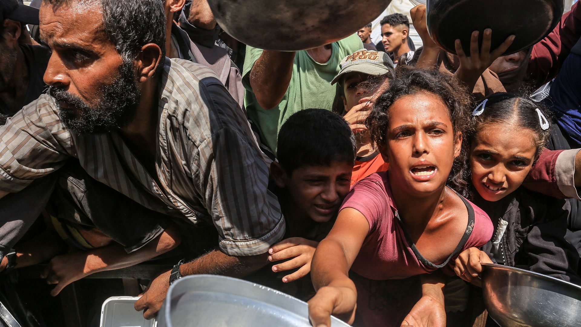 Palestinians wait in line to receive hot meals distributed by the charity organization at Al-Mawasi area in Khan Yunis, Gaza on Aug 21, 2025. A UN-backed monitor has determined there is a famine in parts of the enclave. 
