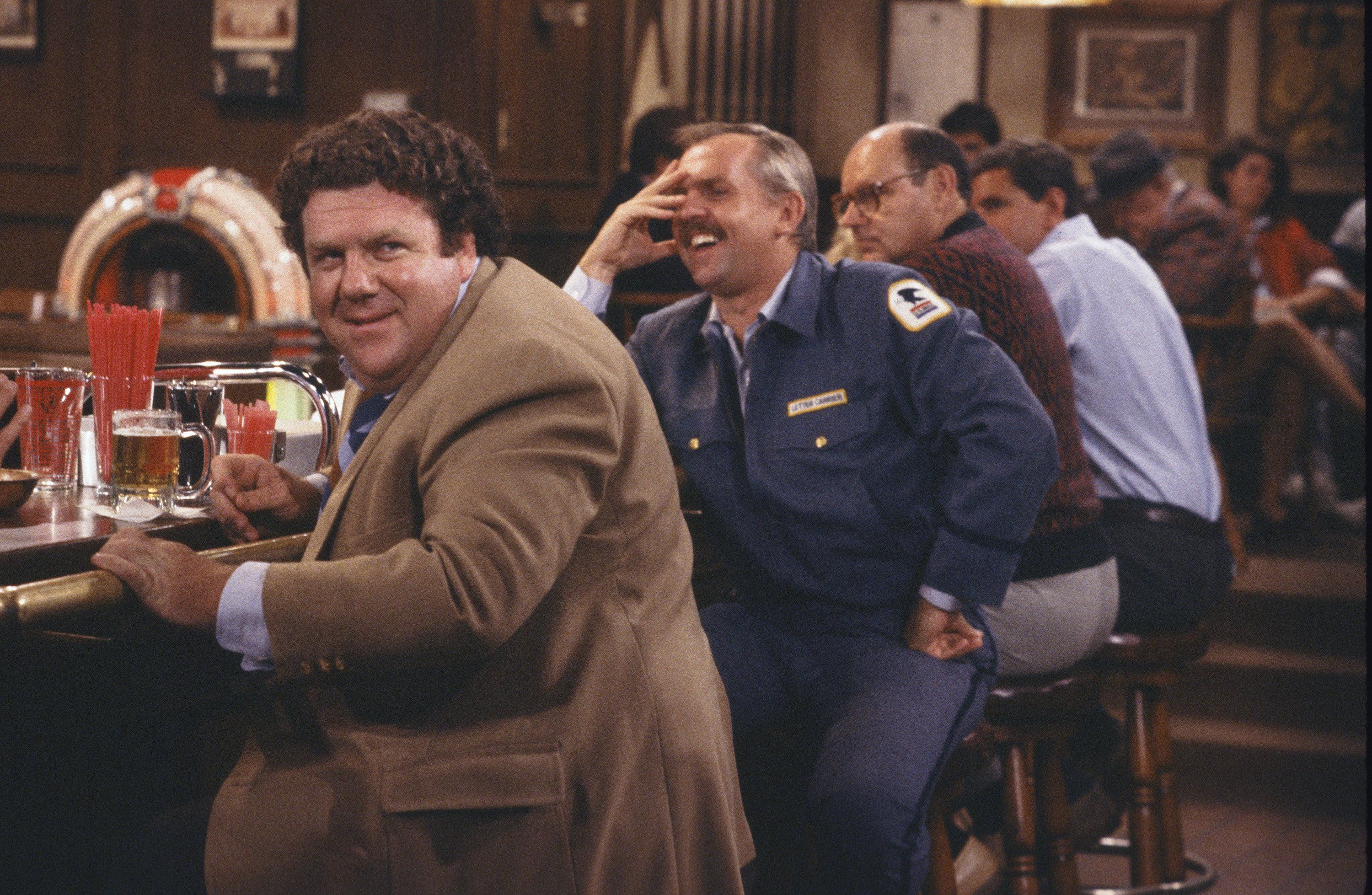 George Wendt and John Ratzenberger sitting at the bar in Cheers.