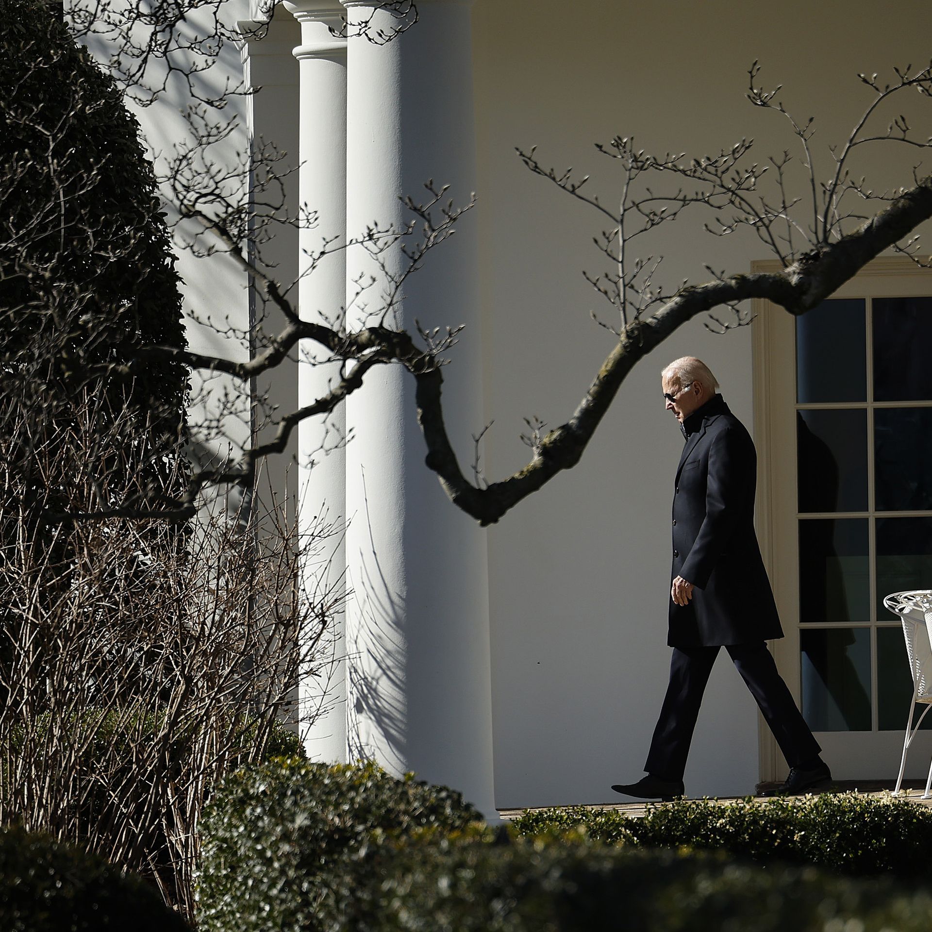 Joe Biden, mid-stride outside the Oval Office, on a bright winter's day