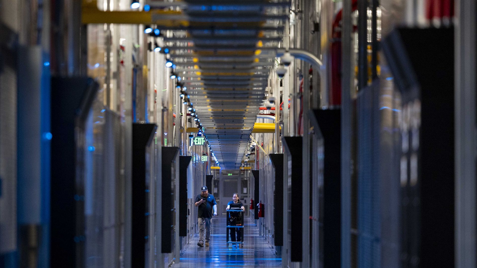 People walk through the hallways a Data Center in Ashburn, Virginia