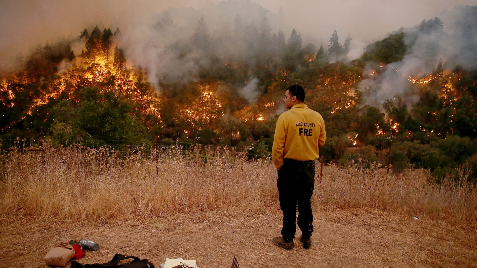 a firefighter looking at the fire