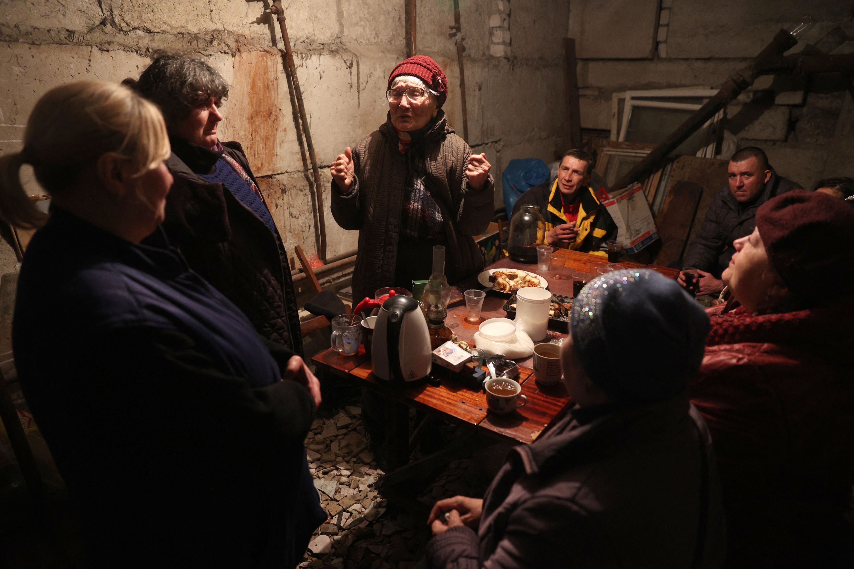 Local residents celebrate a birthday in the basement of a residential building to protect themselves from shelling in Lysychansk in the Luhansk region on April 13.