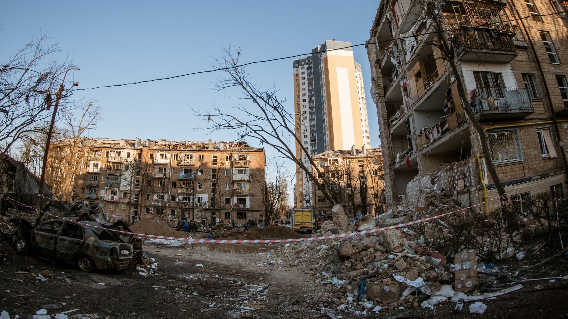 Photo of collapsed buildings, burned cars and rubble