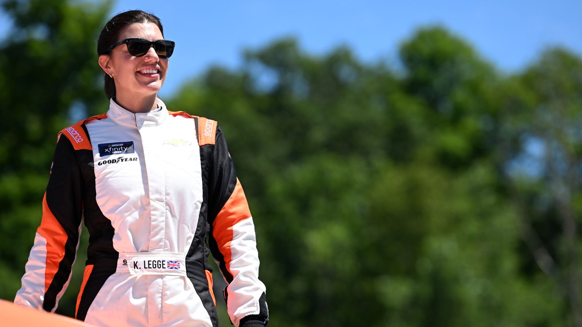 A woman in a racing outfit.