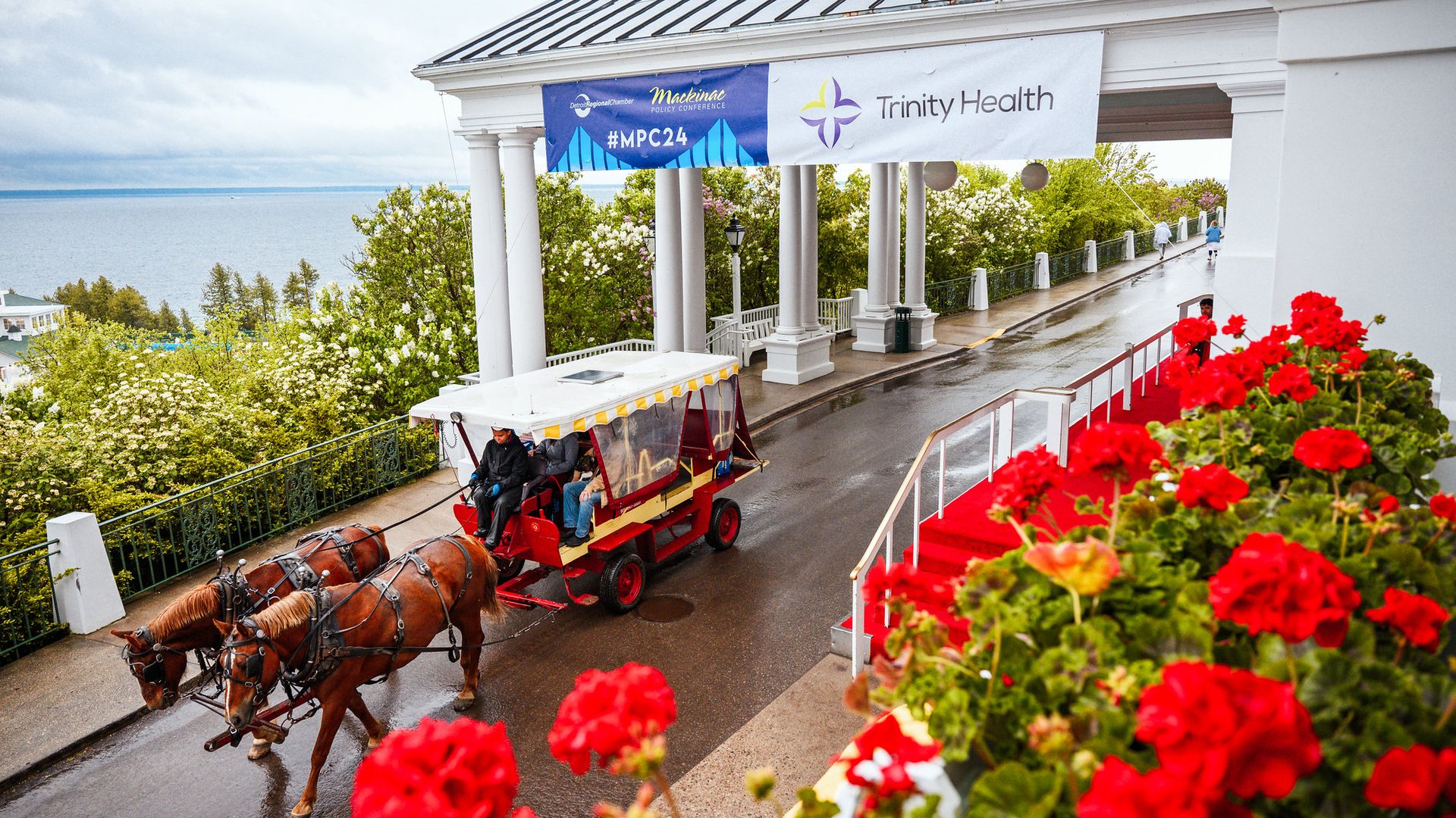 Horses and a carriage leave the Grand Hotel where the conference takes place