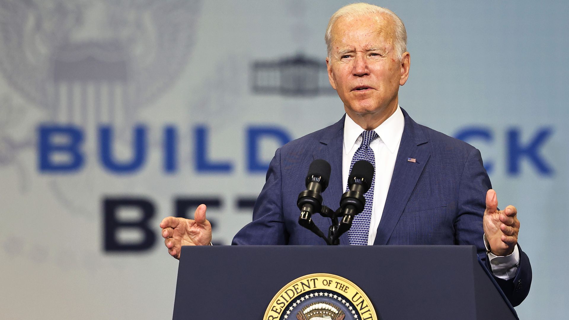 Joe Biden speaks at an event with a "Build Back Better" backdrop
