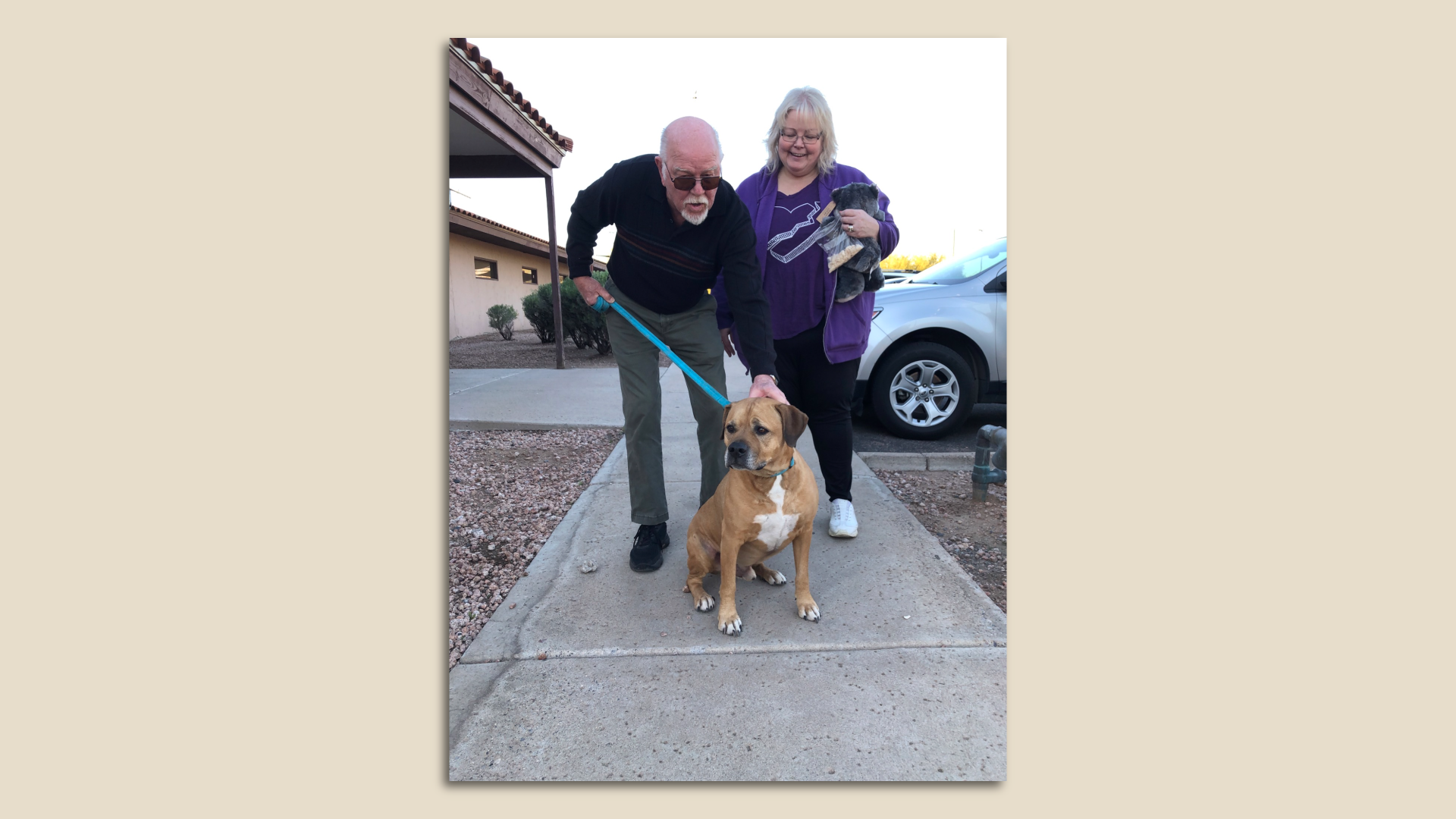 A dog with two people.