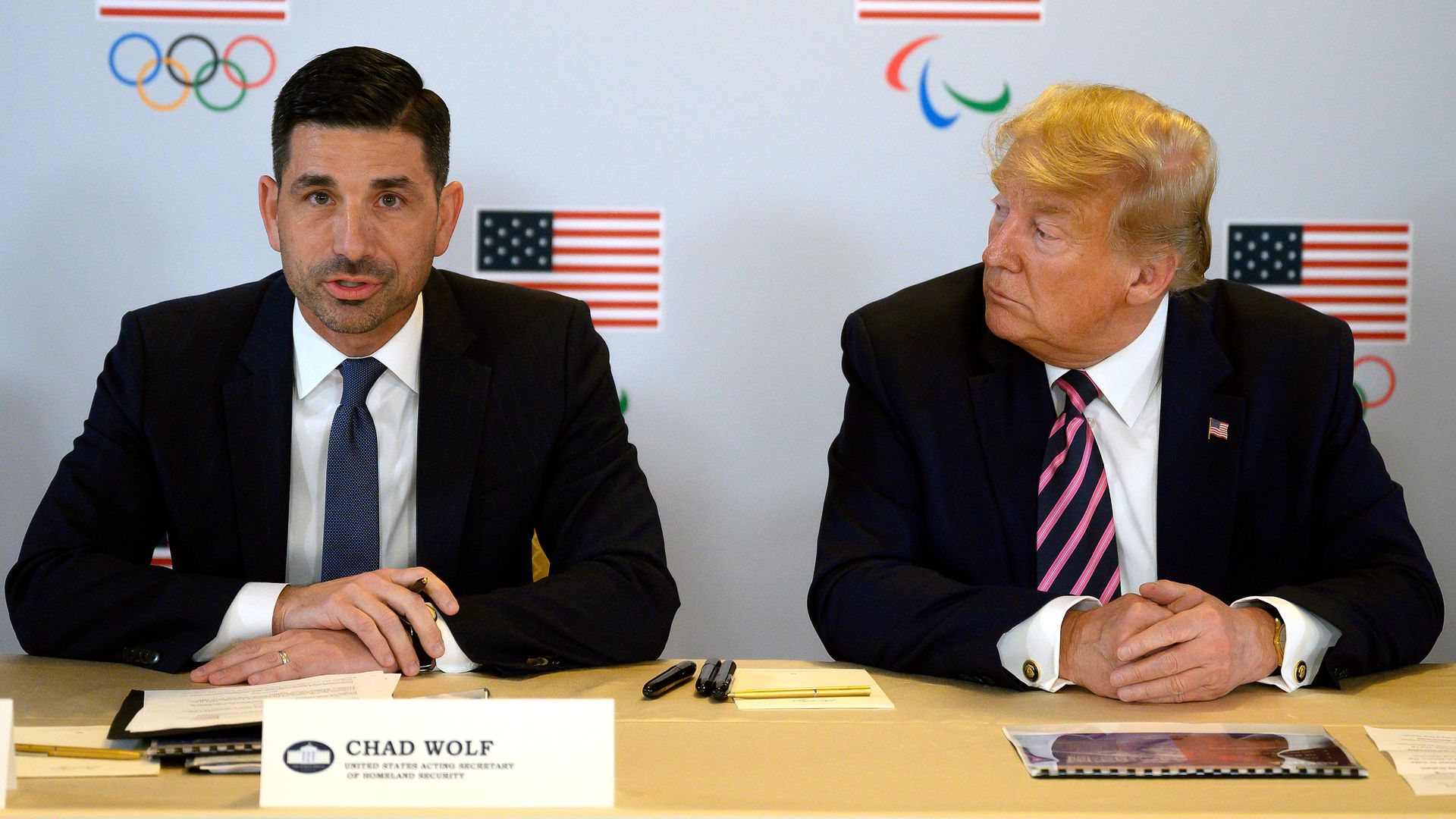 President Donald Trump speaks with Acting Department of Homeland Security Secretary Chad Wolf (L) as he participates in a briefing  in Beverly Hills, California, on February 18