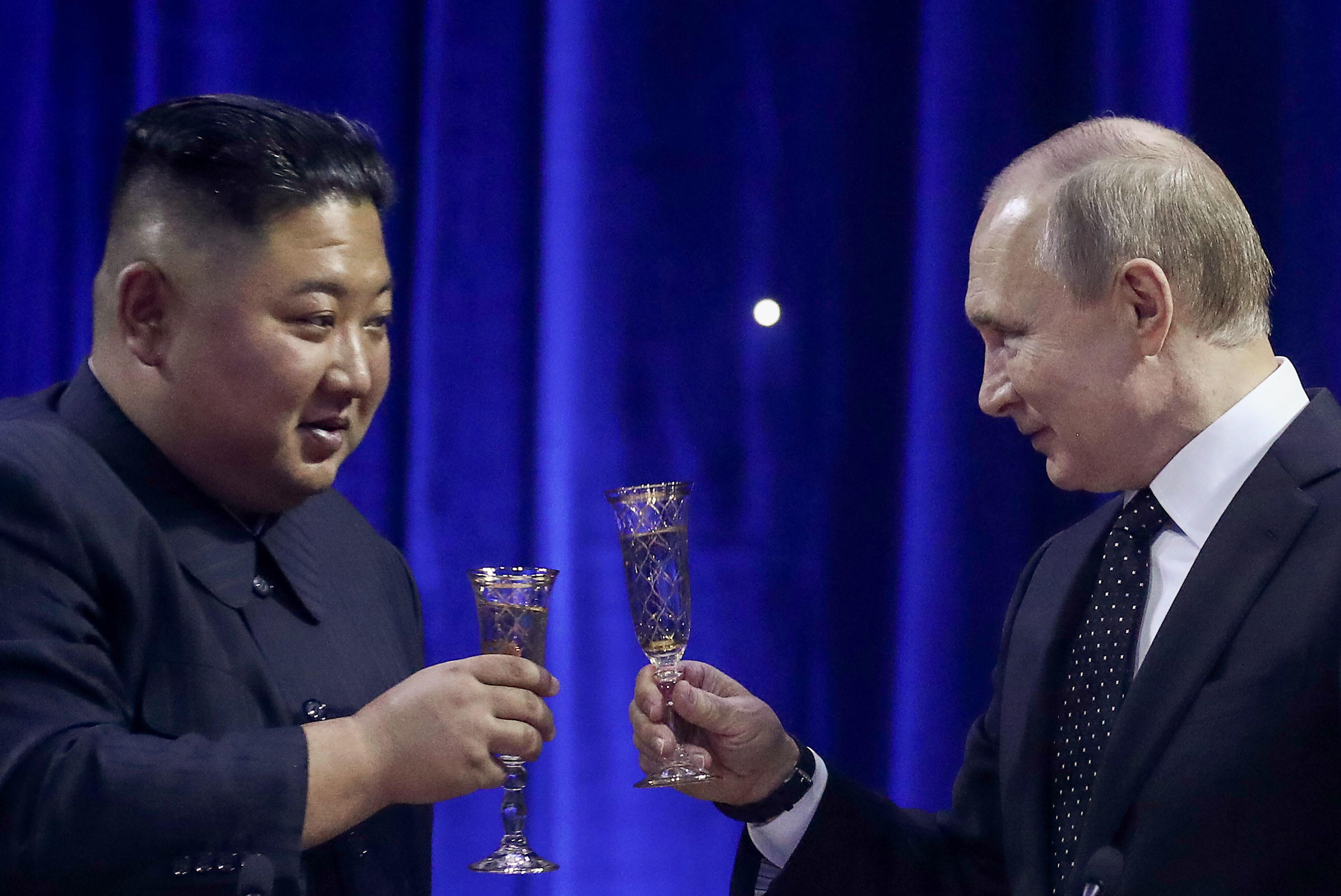 North Korean Leader Kim Jong Un (L) and Russia's President Vladimir Putin clink glasses during a reception after their meeting.