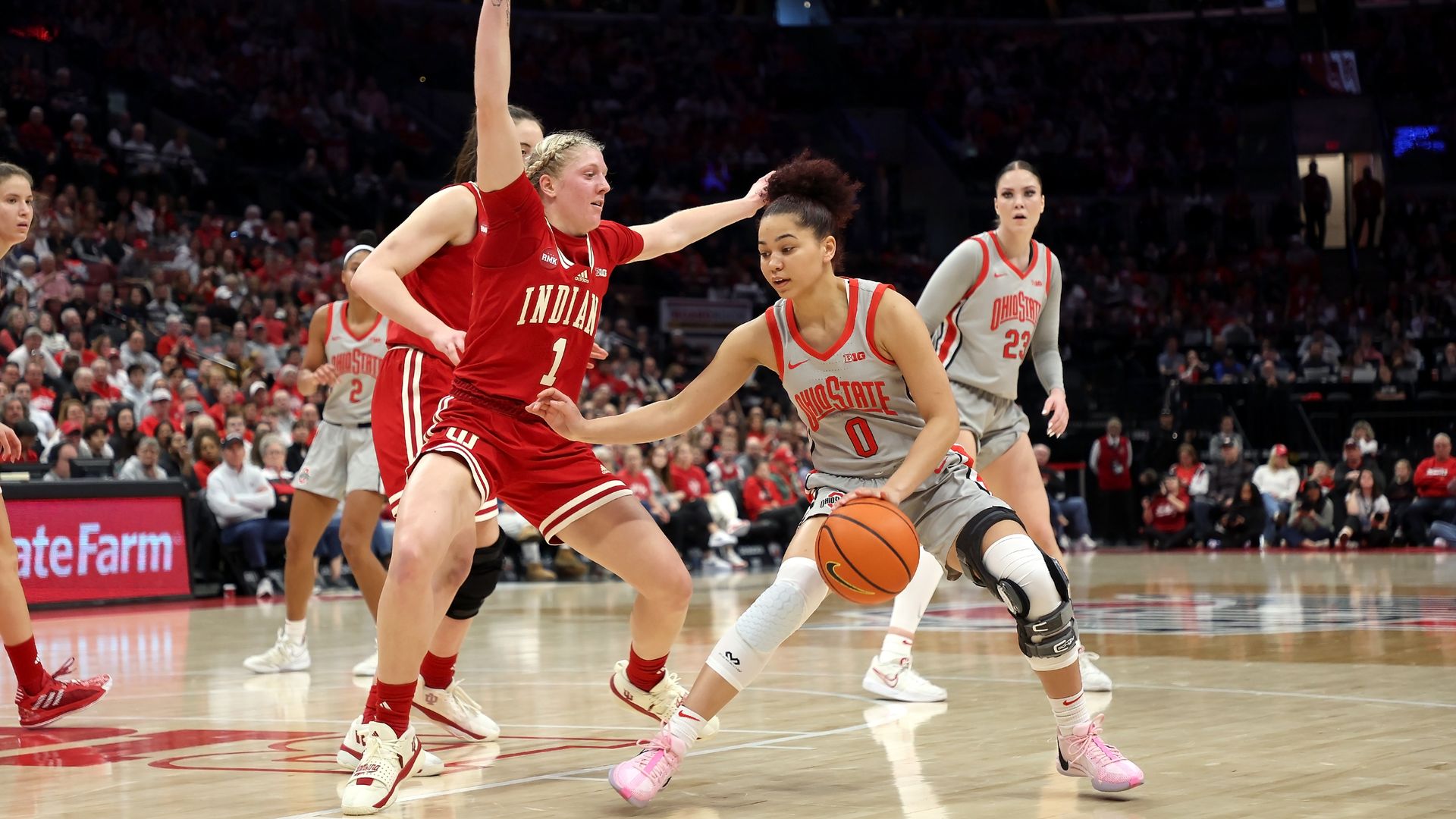 Madison Greene dribbles the basketball while an Indiana player defends. 