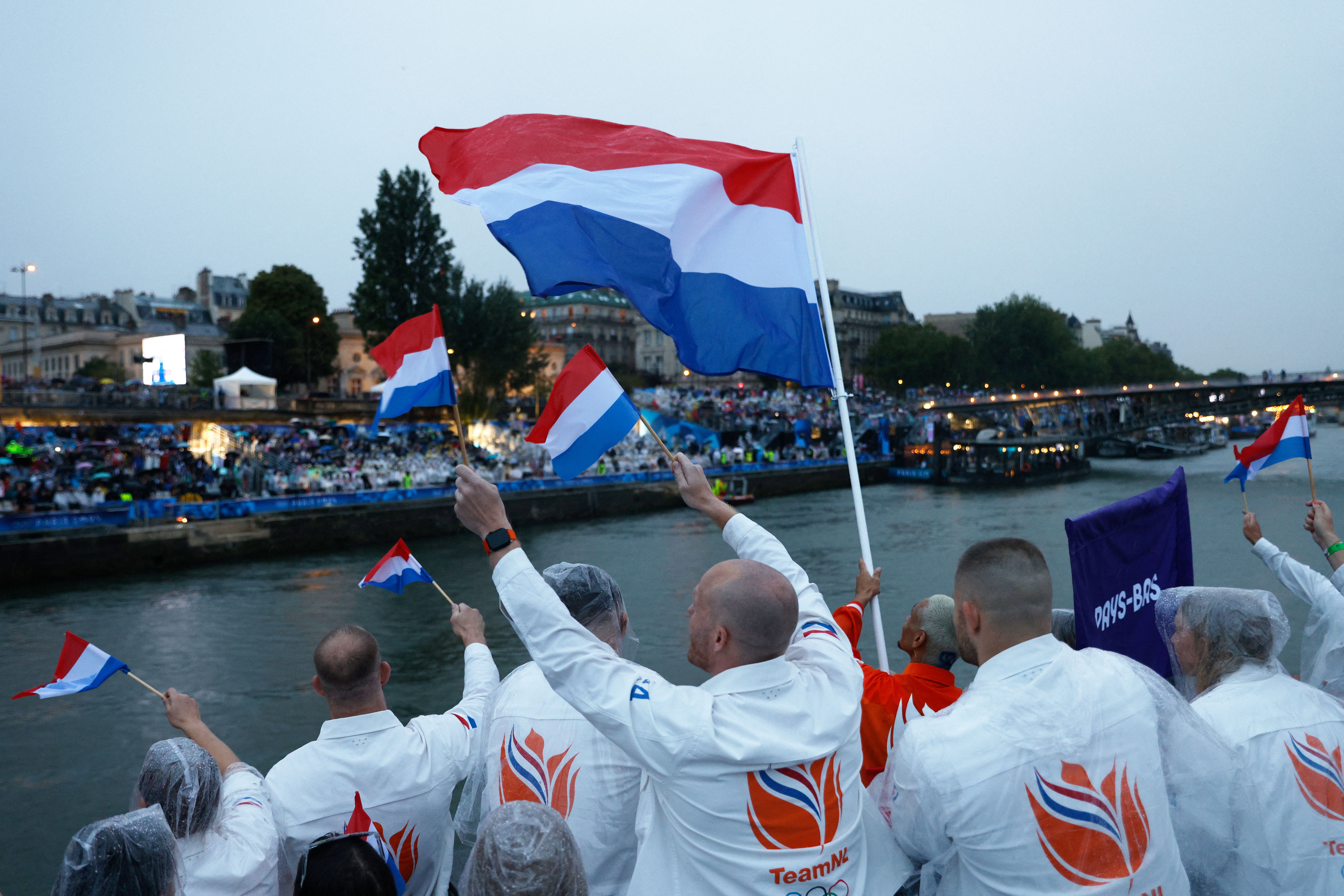 Athletes from The Netherlands' delegation sail in a boat along the river Seine during the opening ceremony of the Paris 2024 Olympic Games in Paris on July 26, 2024. alexan (Photo by GEOFFROY VAN DER HASSELT / POOL / AFP) (Photo by GEOFFROY VAN DER HASSELT/POOL/AFP via Getty Images)