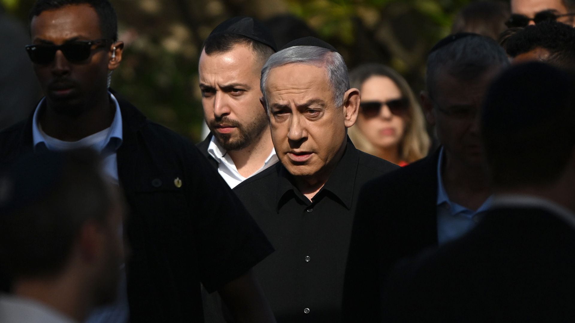 Israeli Prime Minister Benjamin Netanyahu, wearing a black button-down shirt and black yarmulke.