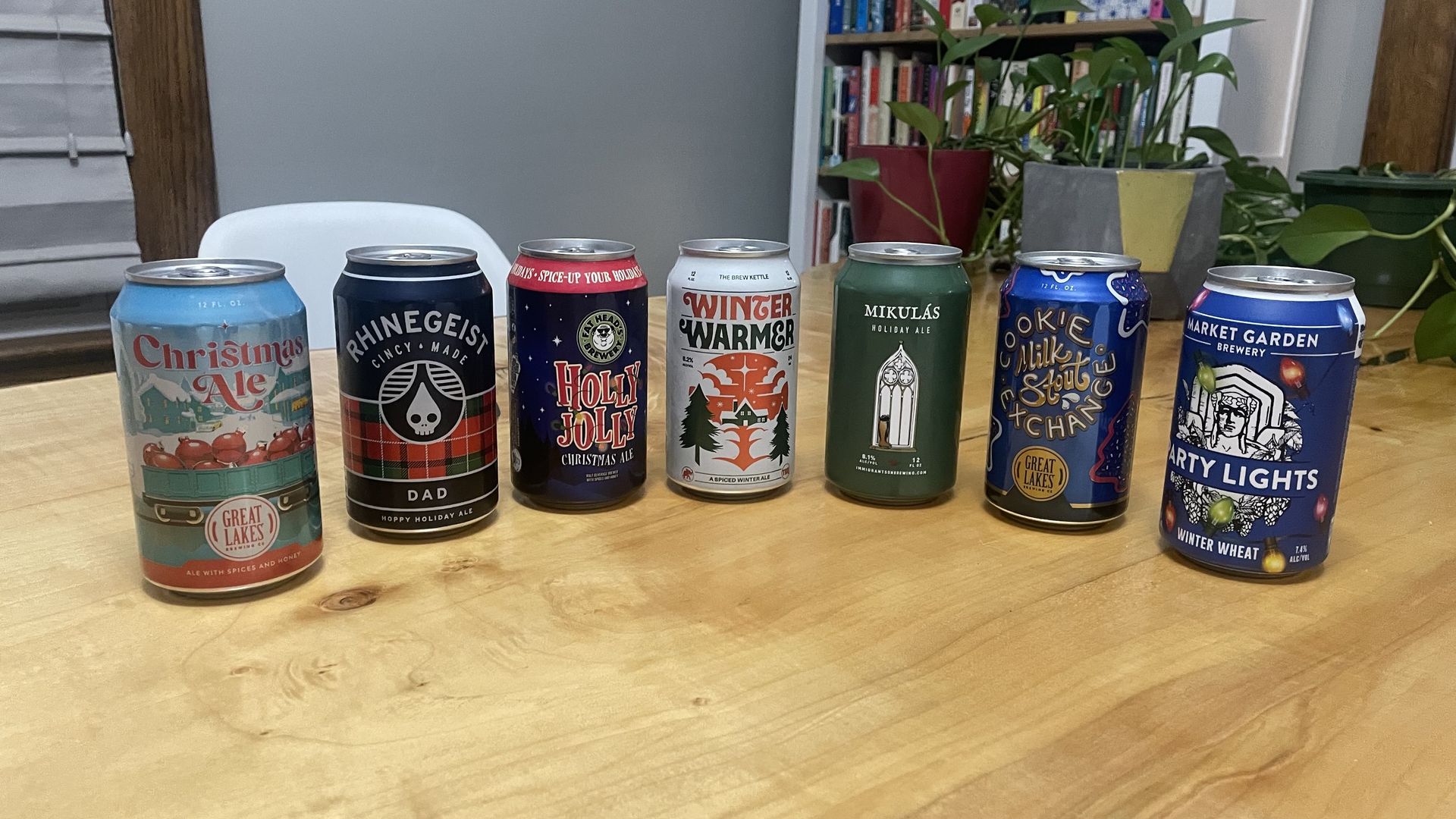 Photo of seven beer cans on a wooden table