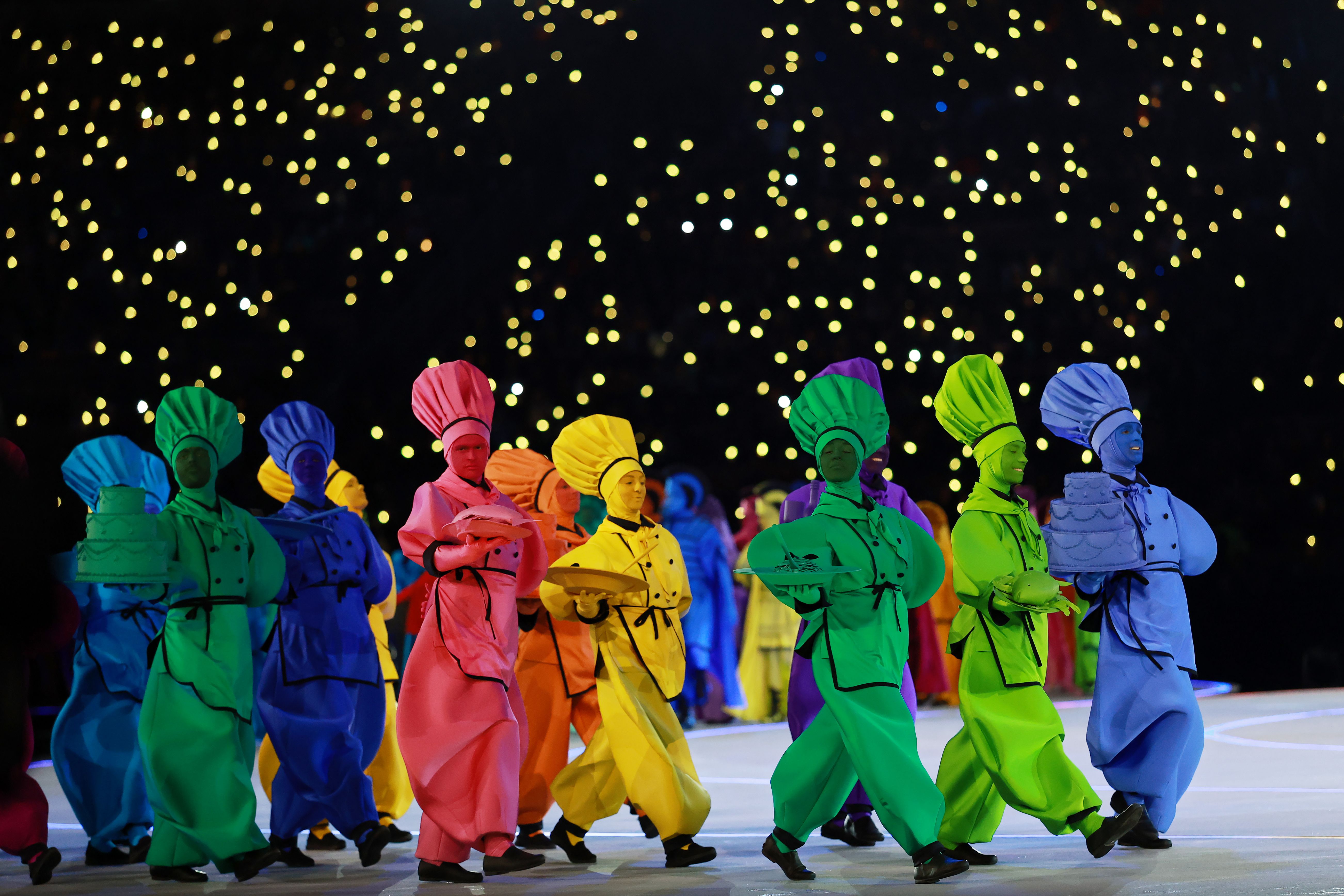 Performers in food-themed costumes take part in the opening ceremony of the 2026 Winter Olympics at San Siro Stadium in Milan