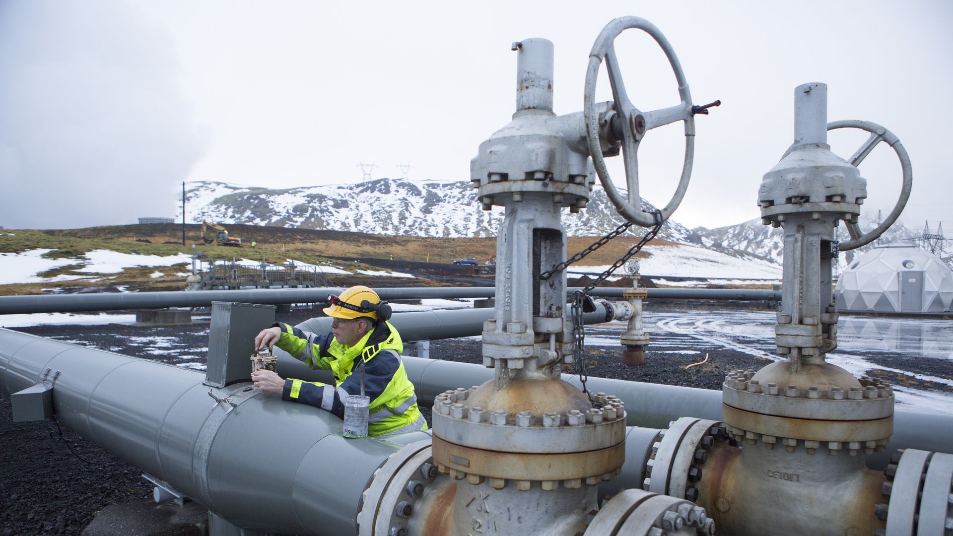 A man works on a pipe beside a carbon injection site well near Reykjavik Energy's Hellisheidi Geothermal Power Plant  outside Reykjavik, Iceland.