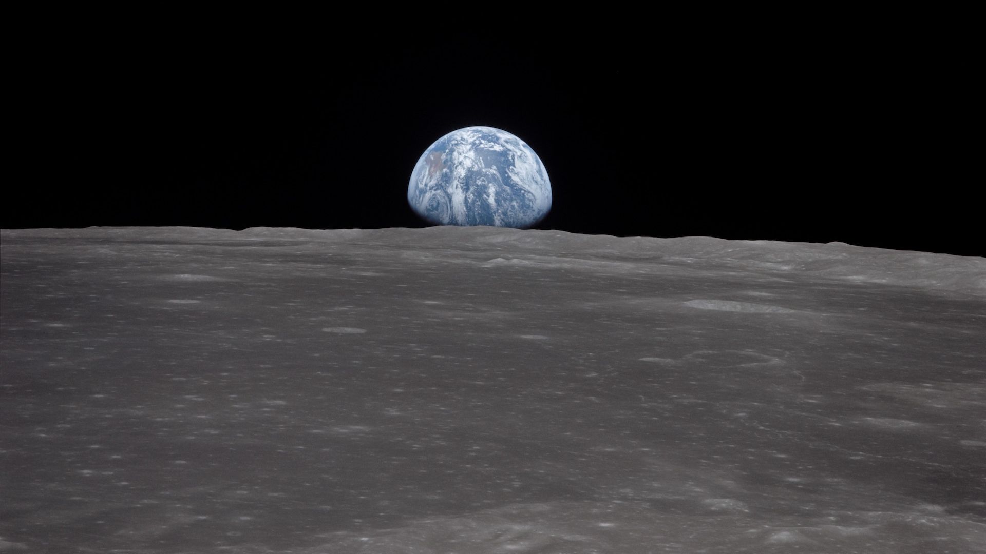 Earth rising above the moon as seen by Apollo 11.