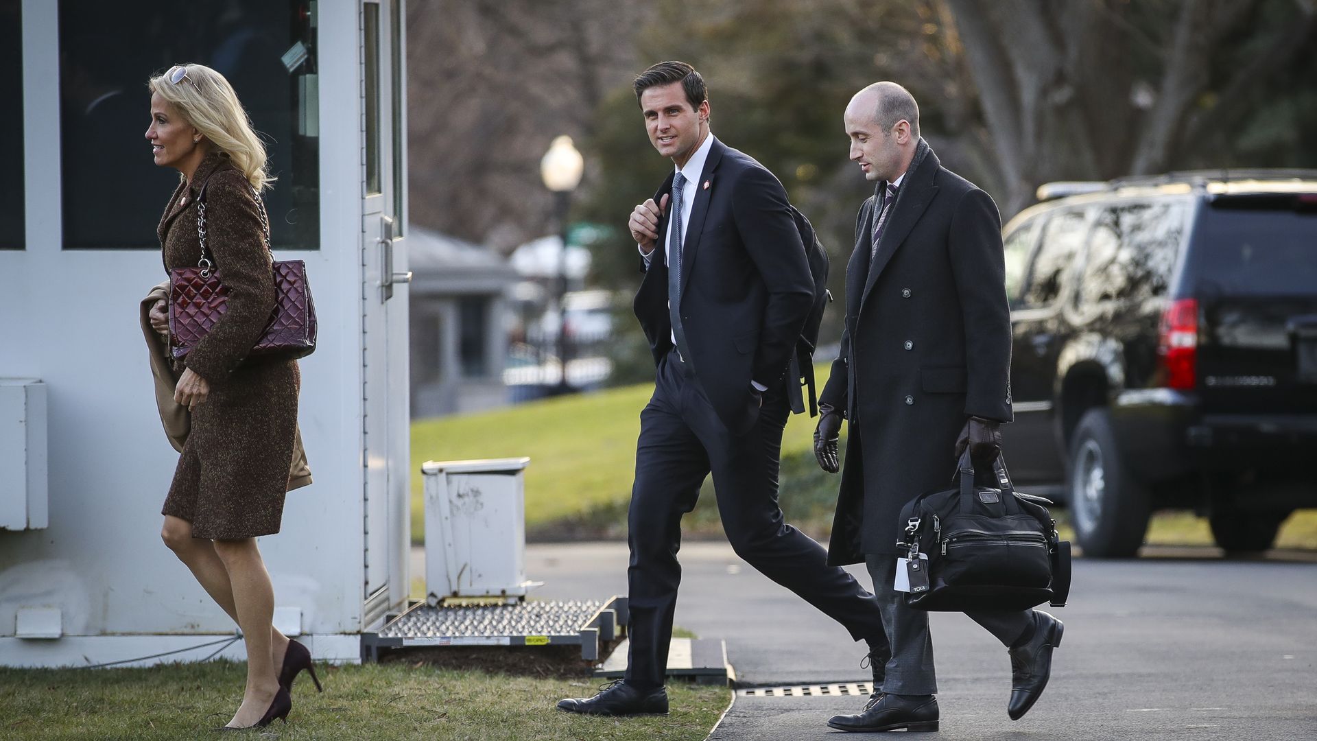 Johnny McEntee walks in the White House driveway