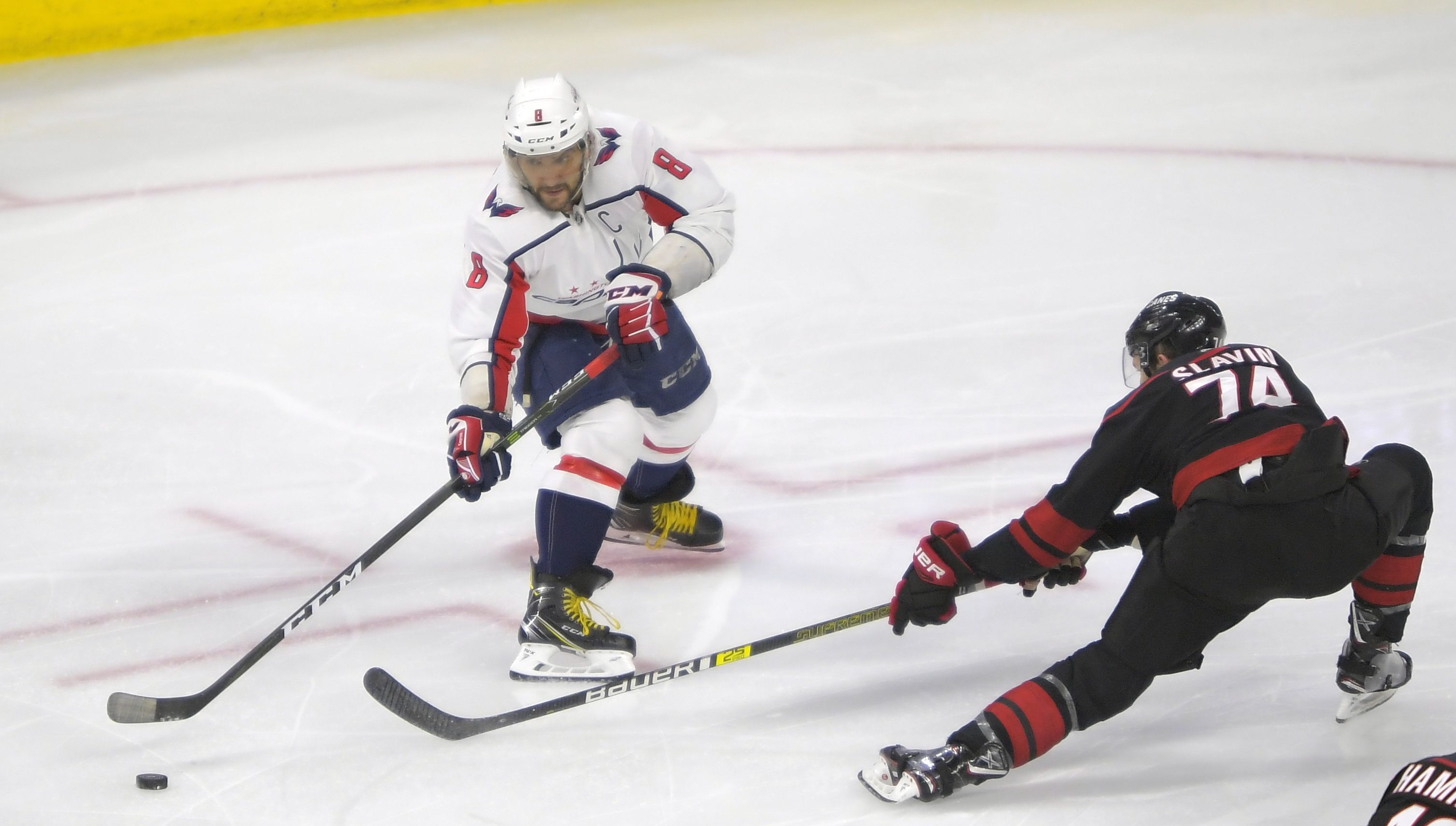Alex Ovechkin passes past a Hurricanes defender