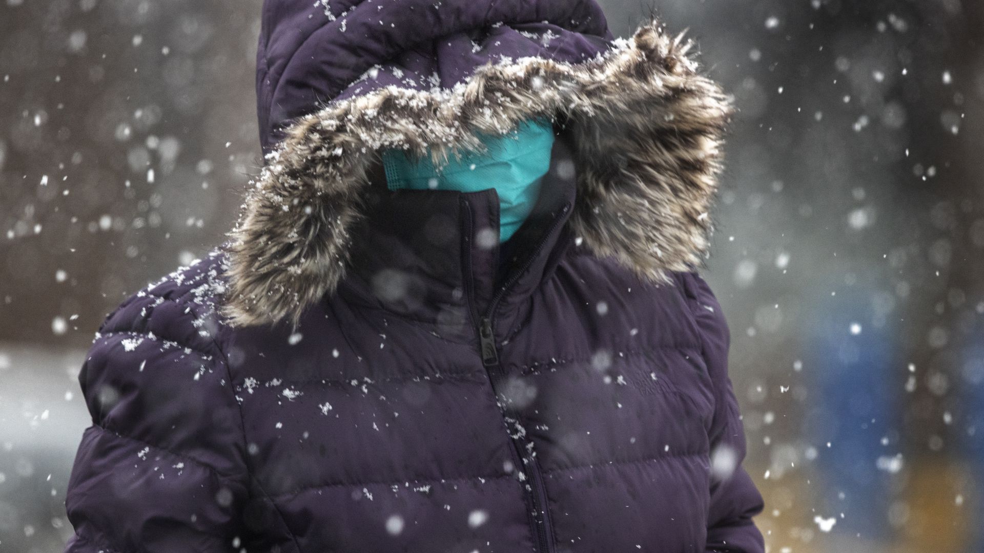 Person wearing a mask in the snow