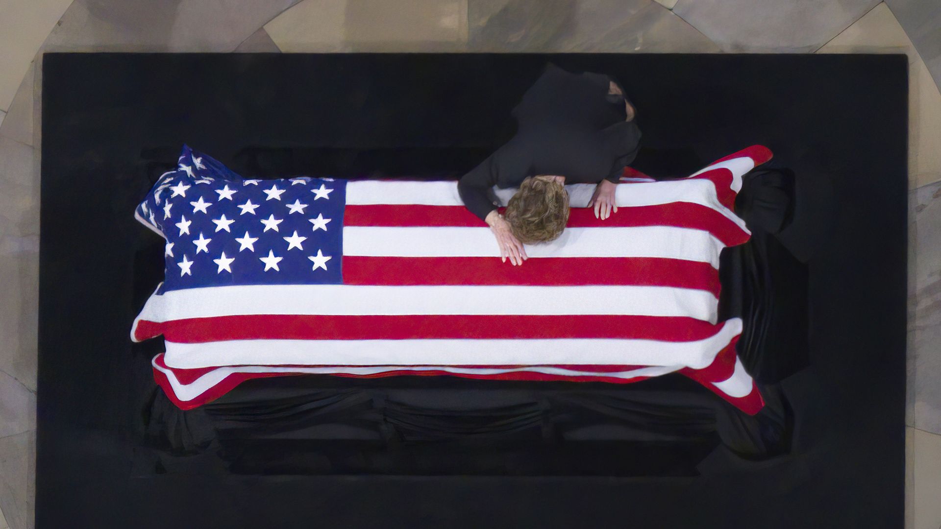 Elizabeth Dole is seen leaning on the casket bearing her husband, former Sen. Bob Dole.