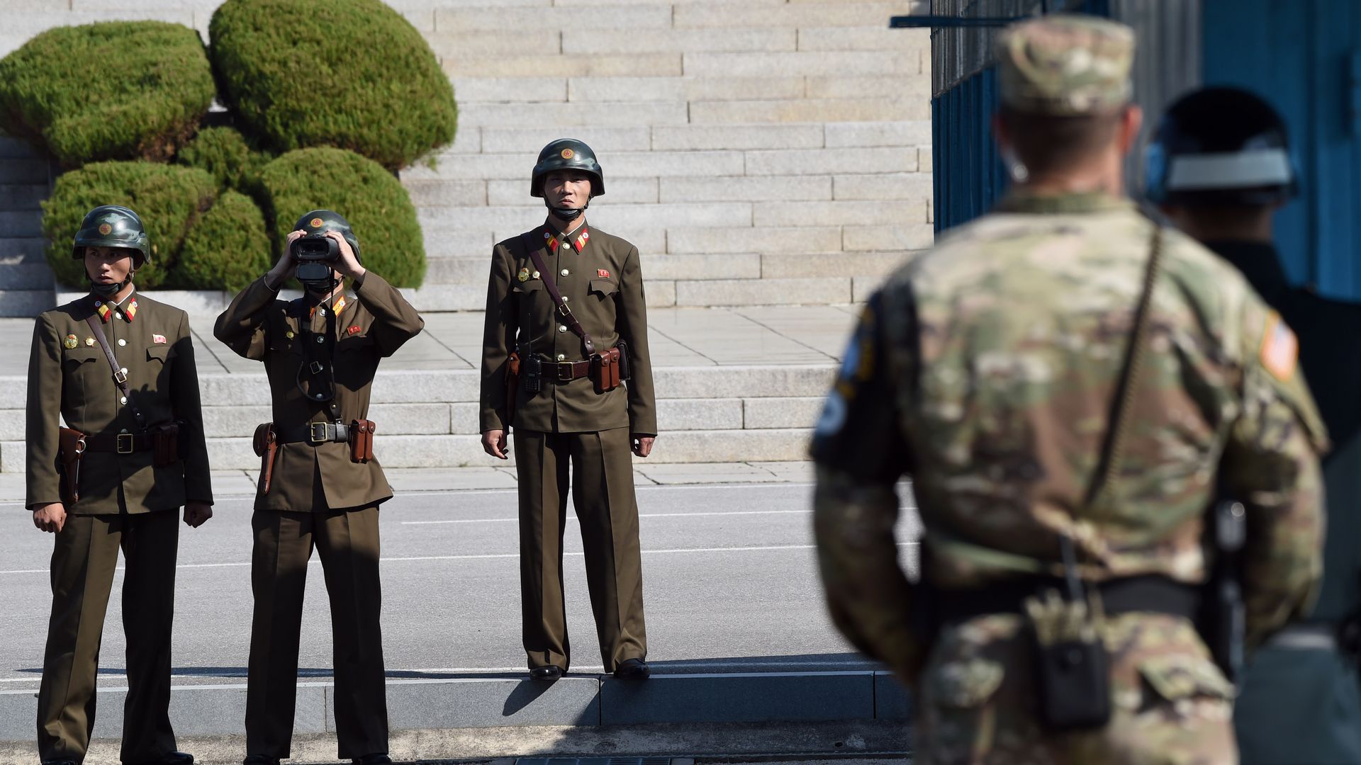 North Korean soldiers look at the South Korean side on the border between North and South Korea on October 27, 2017. 