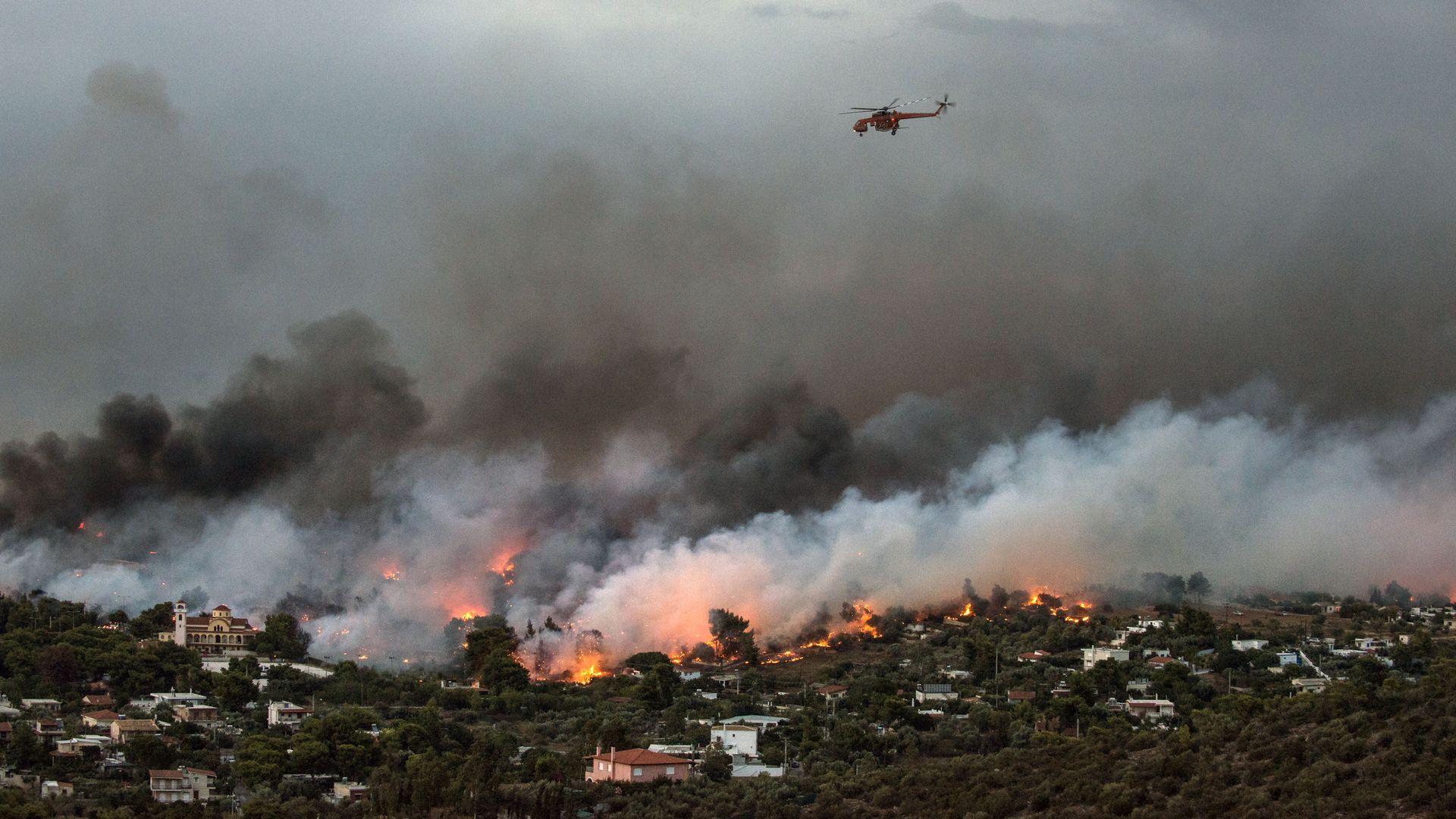 Helicopter flying over wildfires in Greece