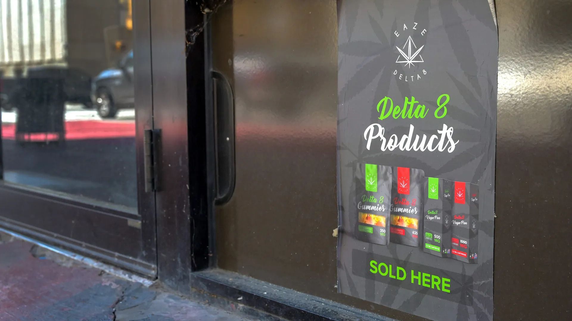 A sign next to a door advertises Delta 8 products for sale. 