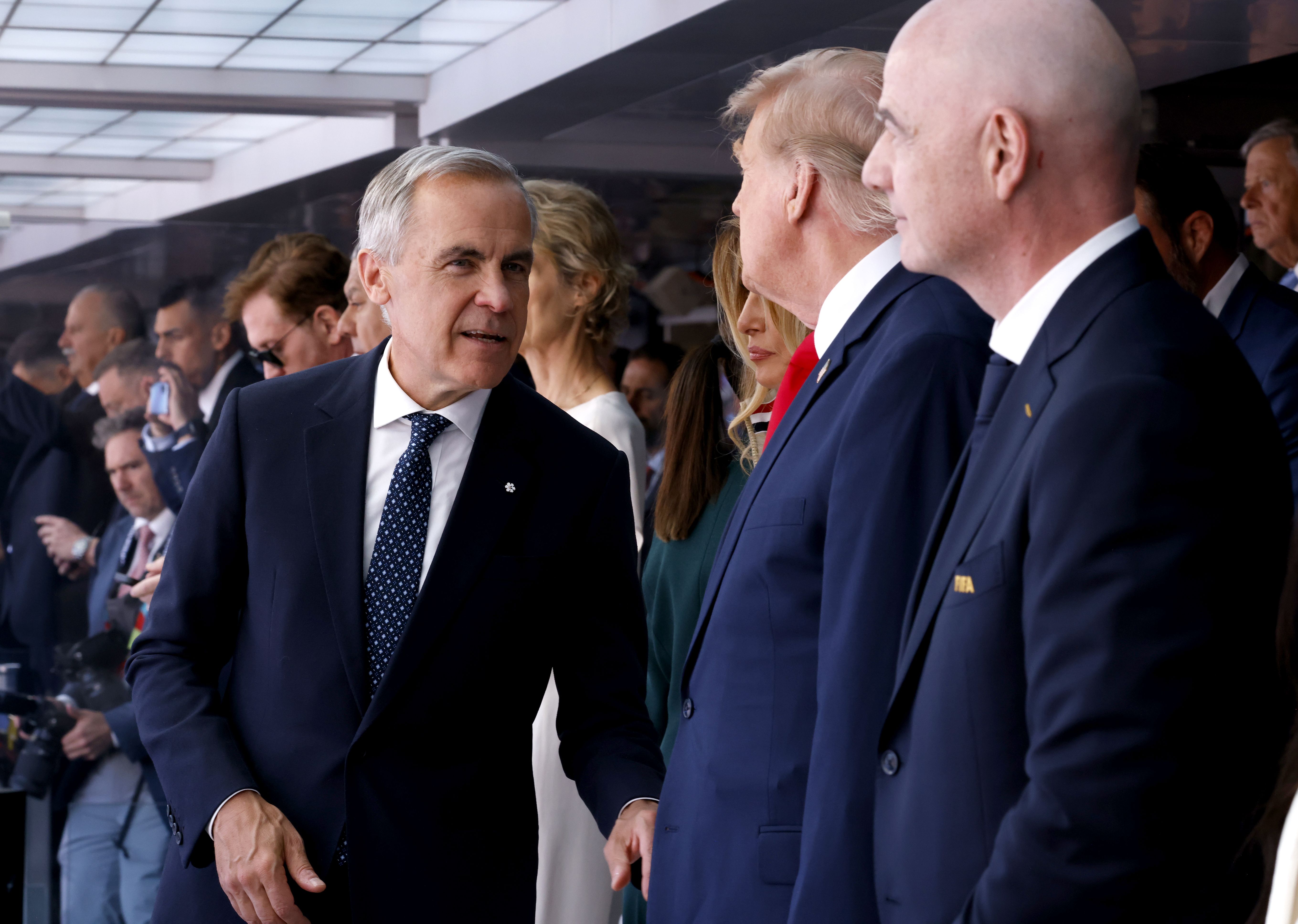 Canadian Prime Minister Mark Carney greets President Trump at the World Cup final on Sunday.