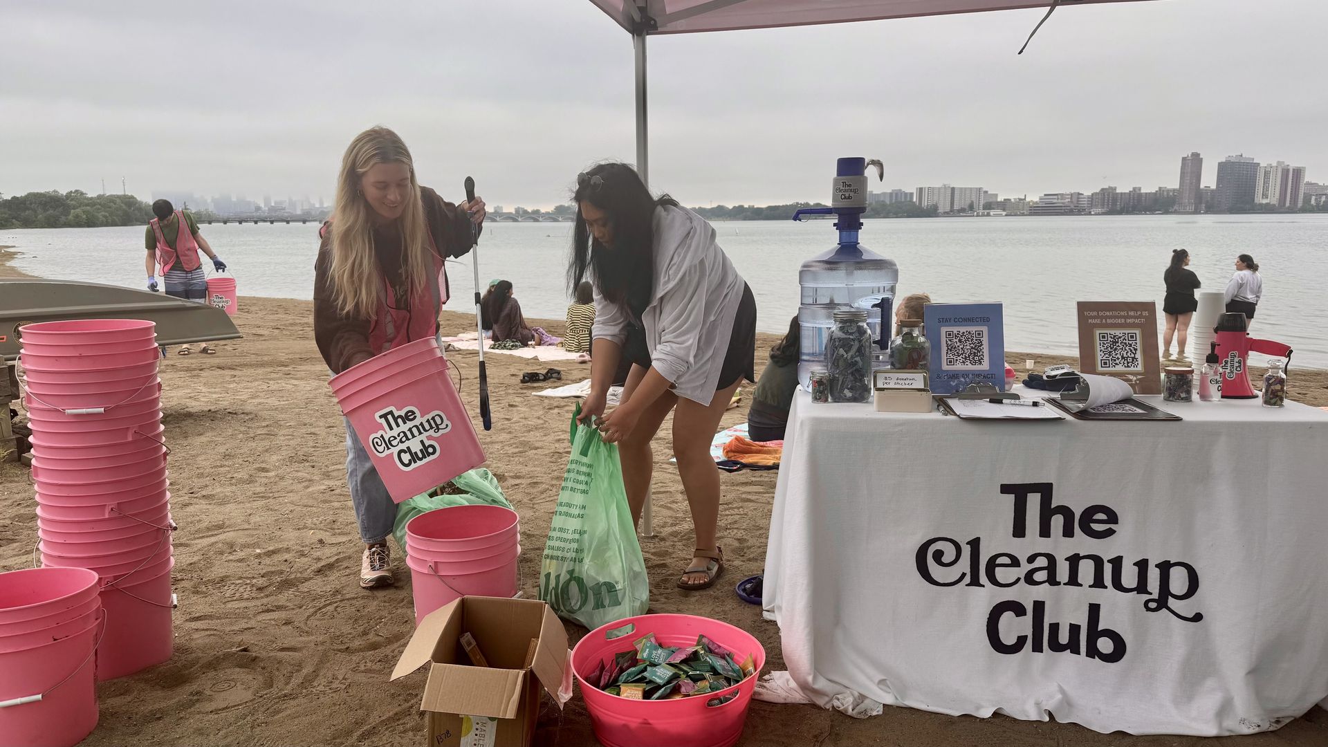 Hannah Tizedes (left) manning the Cleanup Club station on Friday along the Detroit River. 