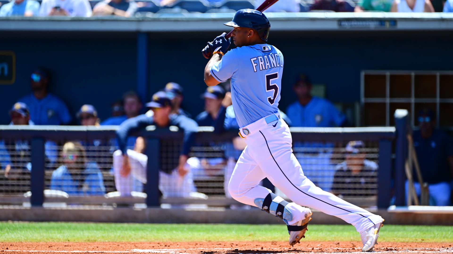 wander franco runs forward holding a bat