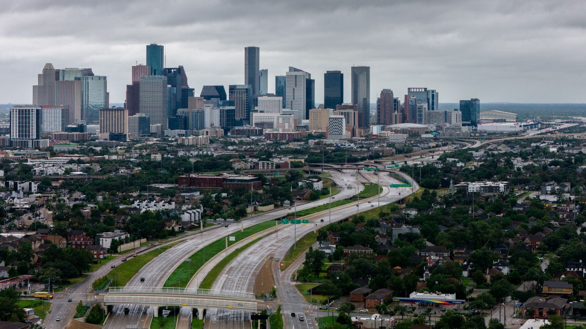 An aerial view of a skyline with highway leading up to it