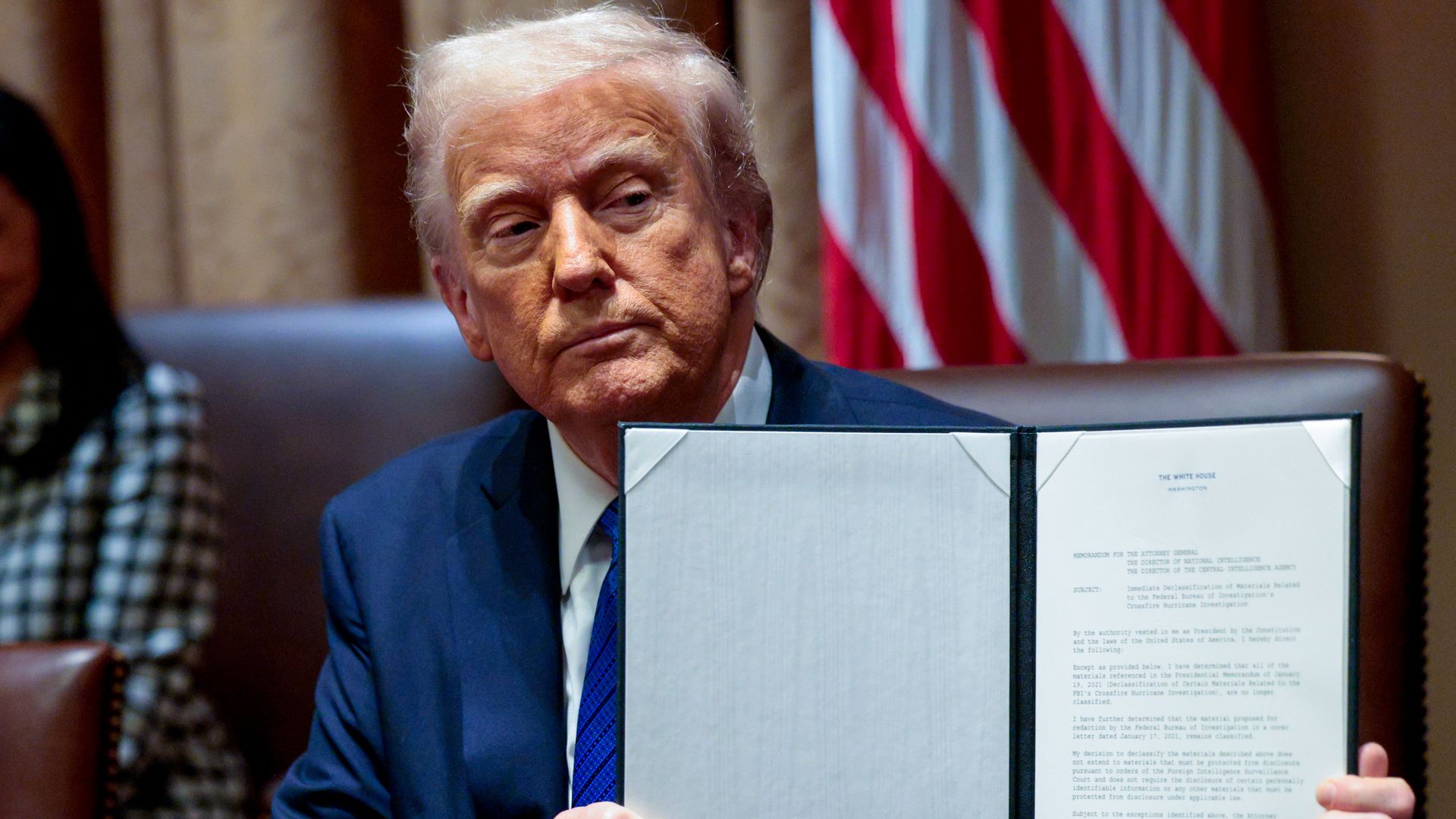President Donald Trump displays a signed executive order during a US ambassadors meeting in the Cabinet Room of the White House in Washington, DC, US, on Tuesday, March 25, 2025