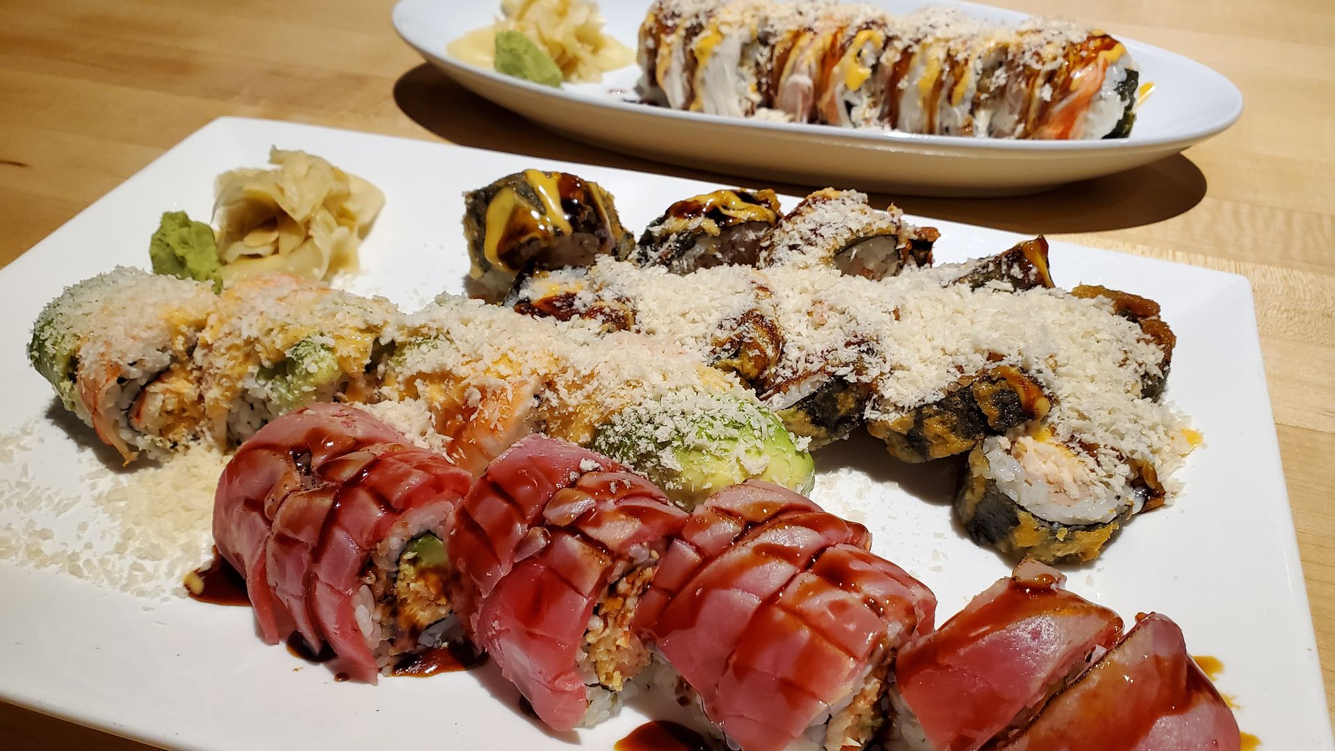 Rows of sushi rolls on a plate