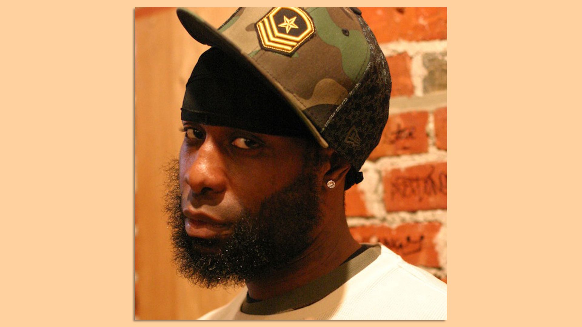 A photo of Jamal Gray, aka The Last Emperor, wearing a hat.