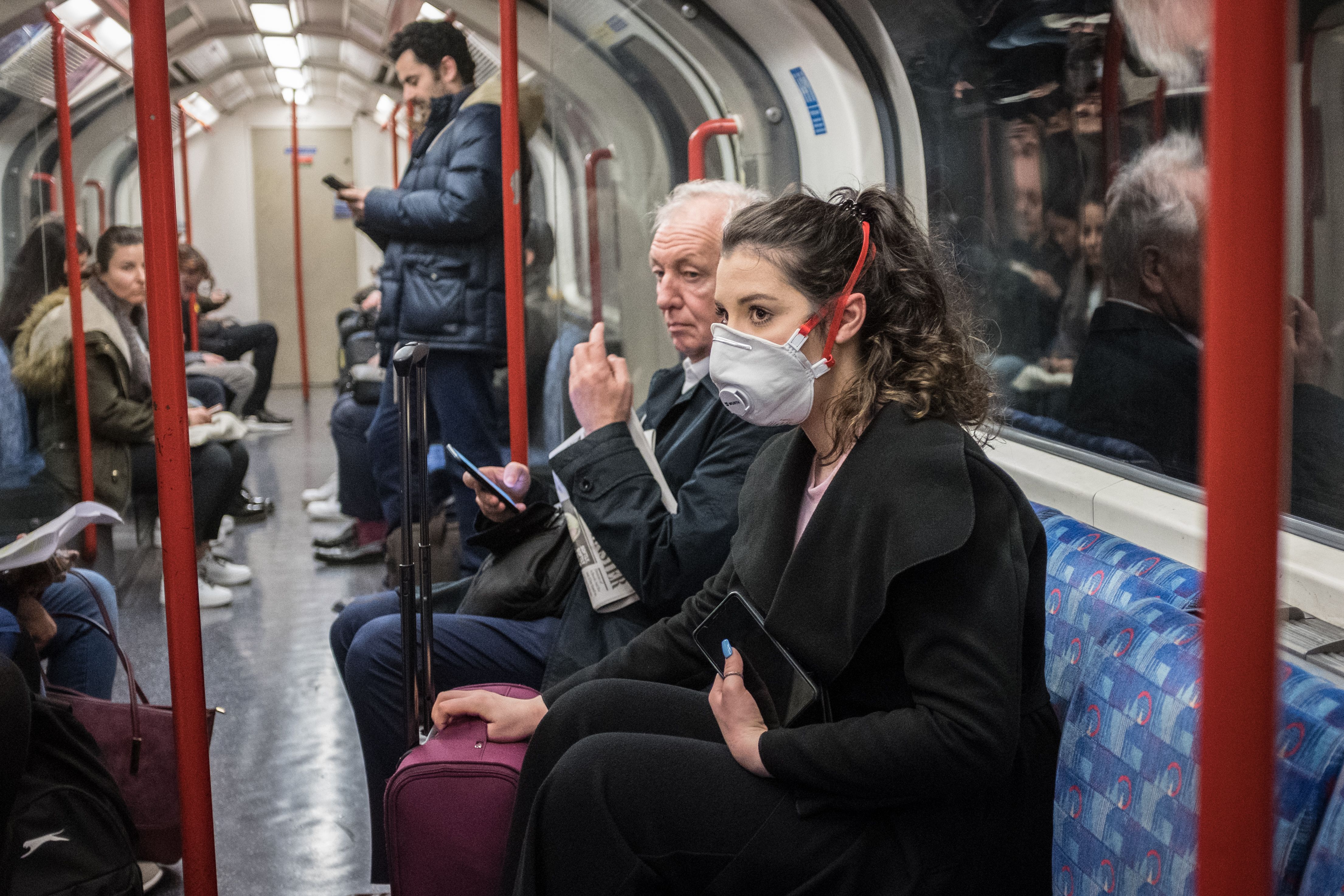 A woman seen on a tube wearing a face mask in London