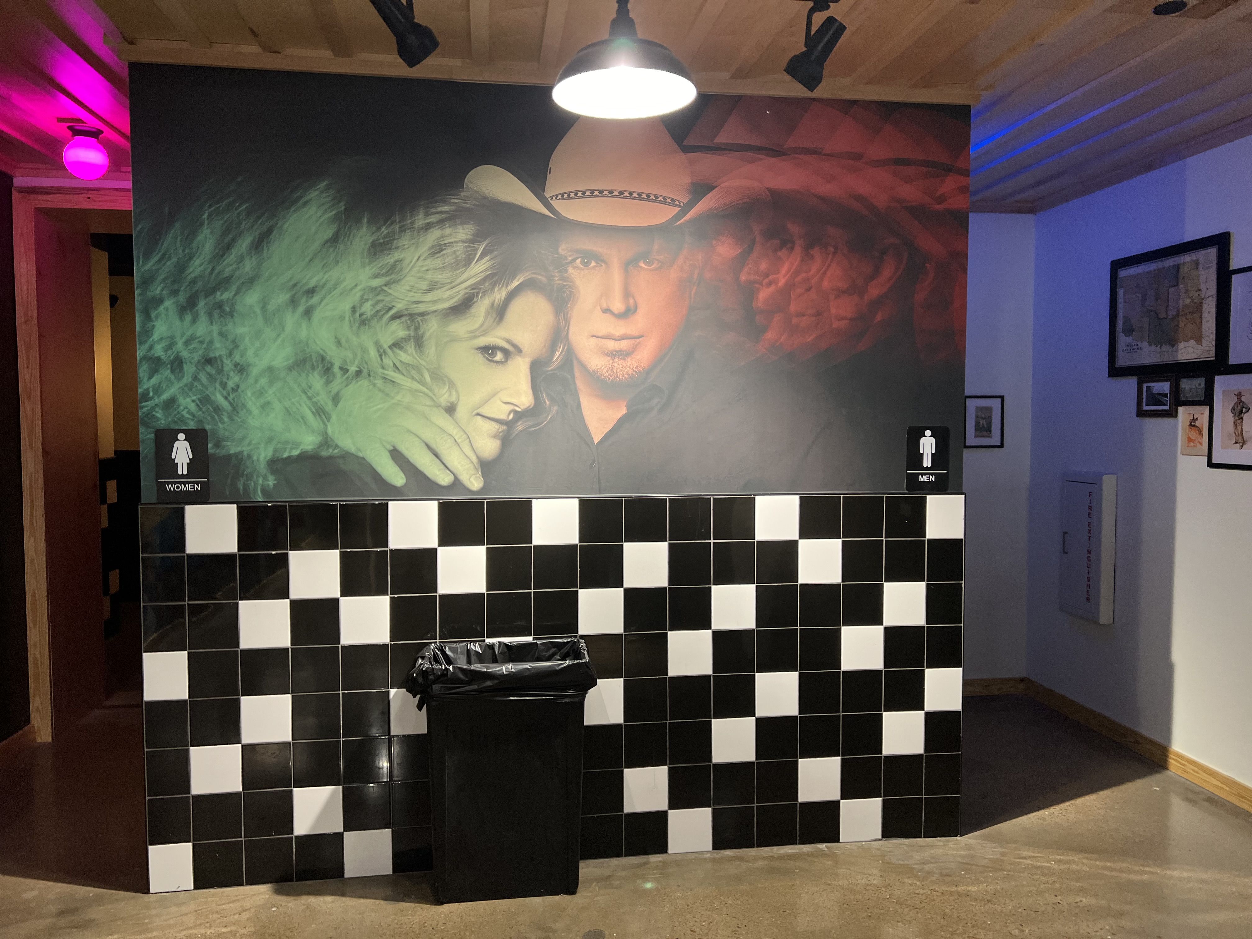 The bathrooms at Friends in Low Places, adorned by pictures of Garth and Trisha.