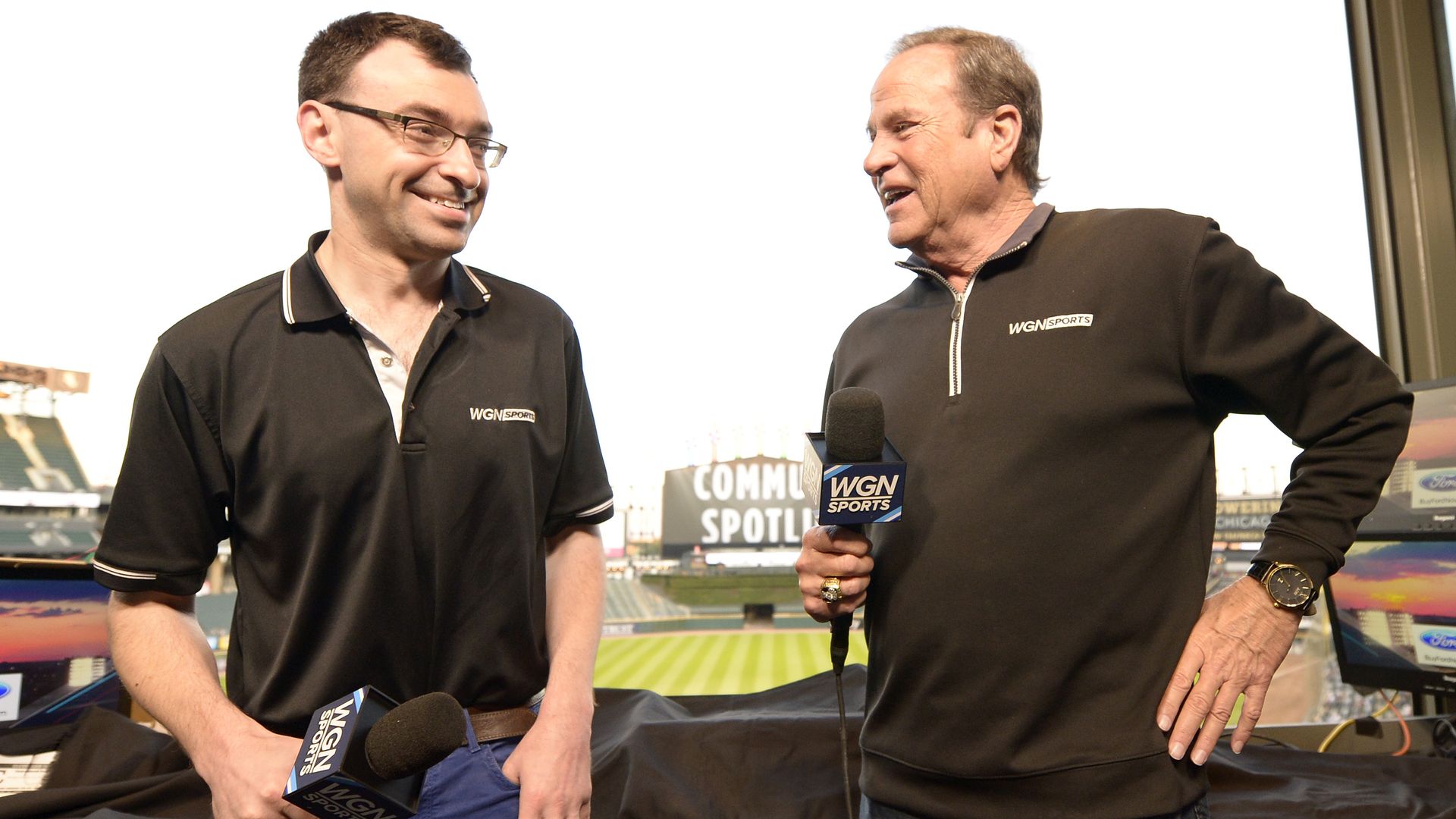 Photo of two broadcasters in a booth