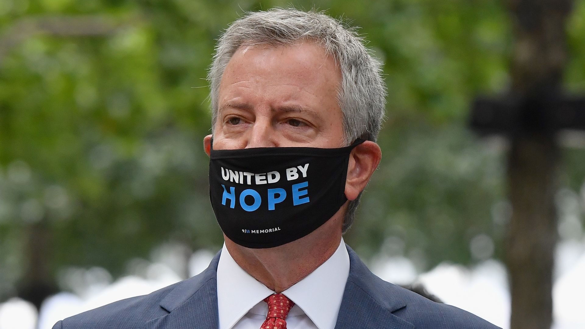 Mayor Bill de Blasio wears a face mask that reads "stand by hope" 