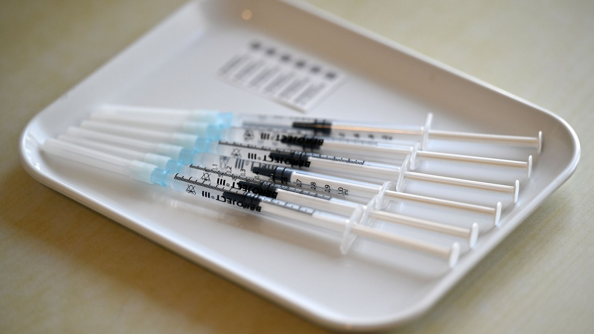 A bunch of syringes on a plate.