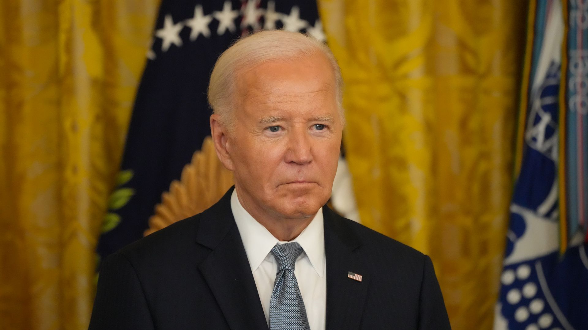 President Biden looks on at a ceremony.