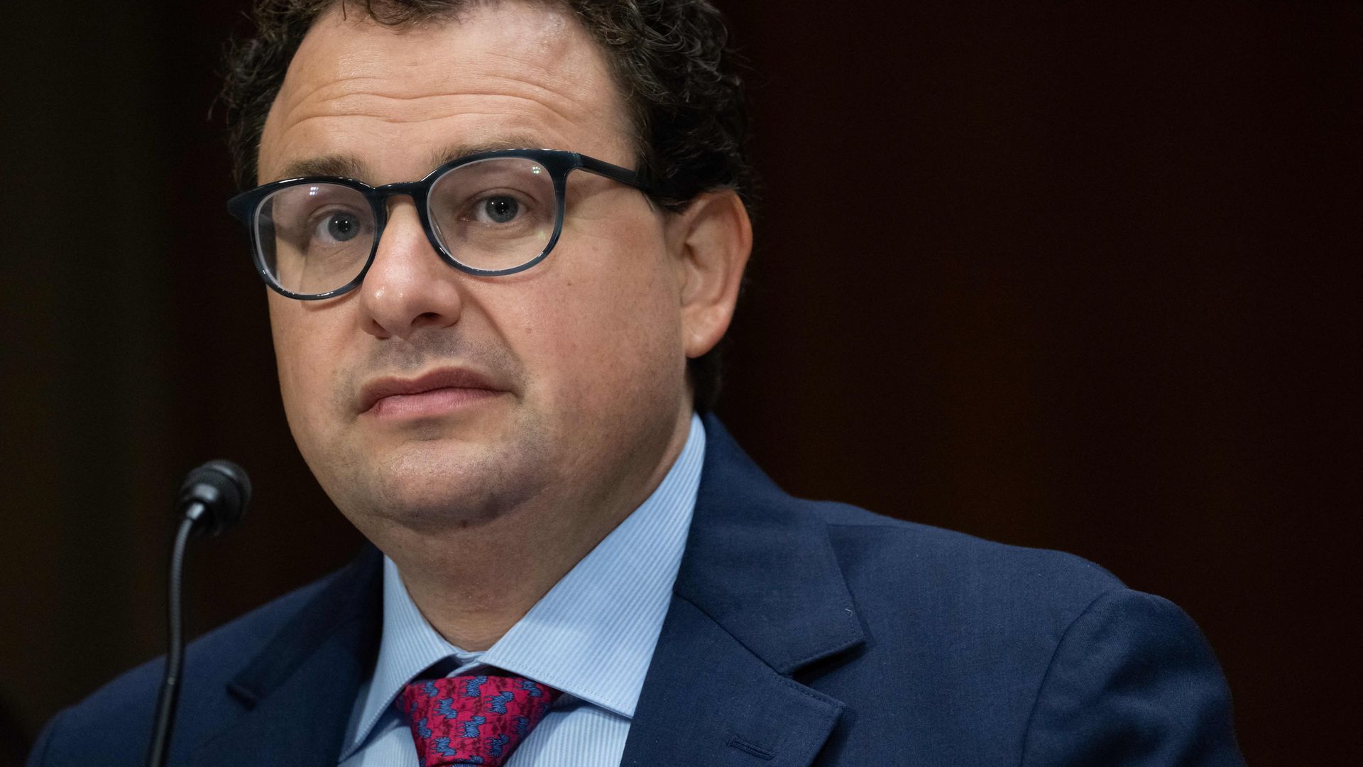 An image of Dario Amodei, CEO of Anthropic, in front of a mic testifying before a U.S. Senate hearing on Capitol Hill. 