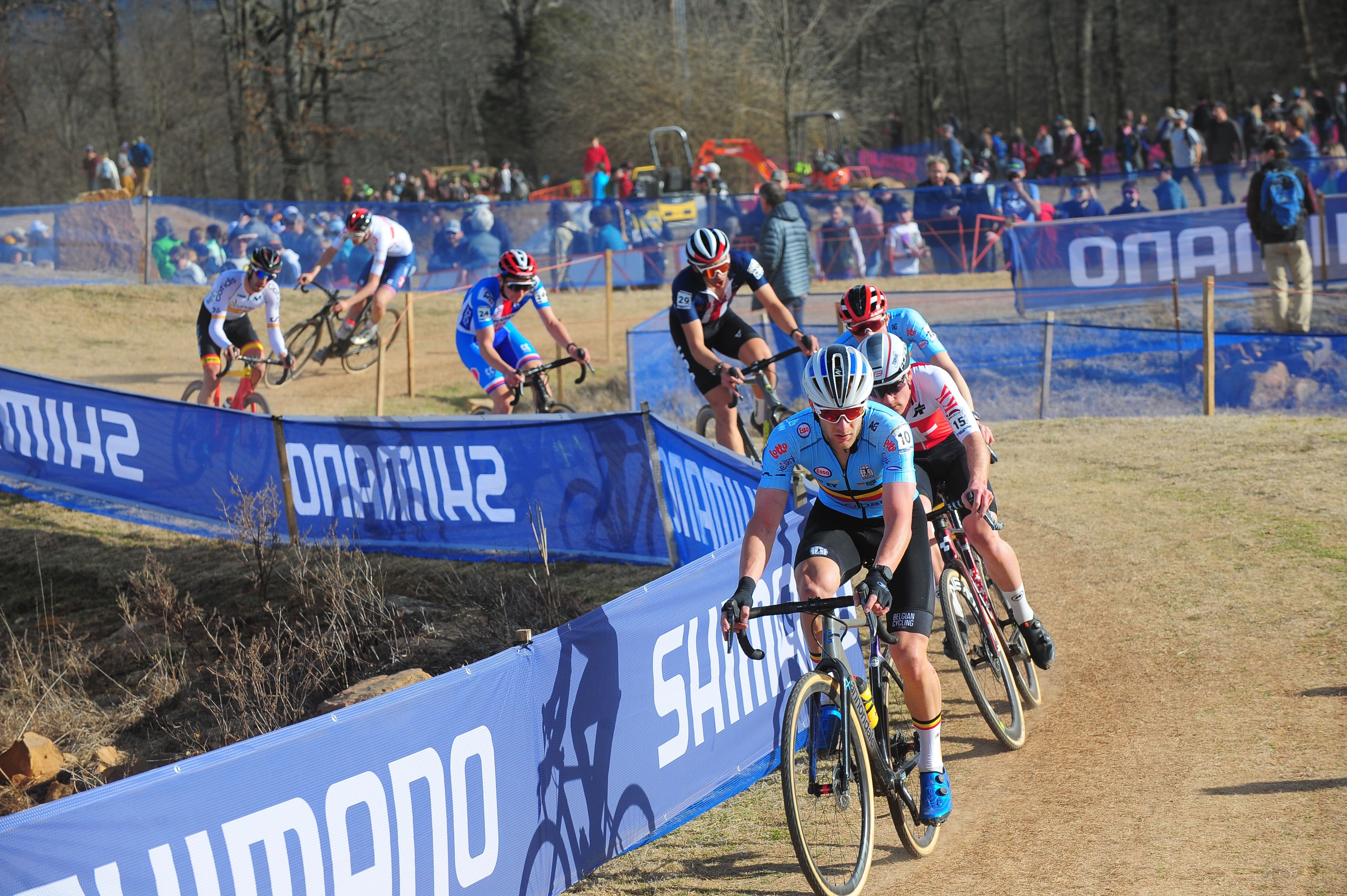 Men cycle in a cyclo-cross event. 