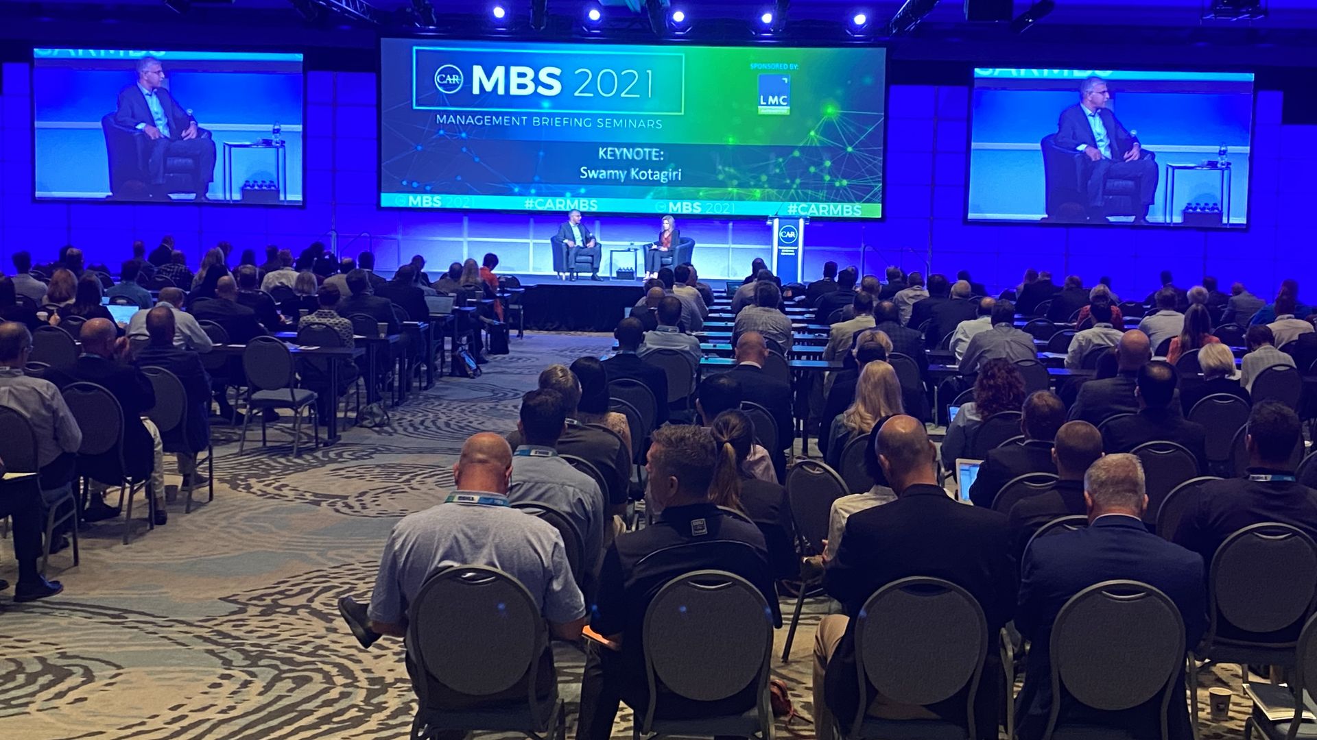 Image of attendees at a large automotive conference in Traverse City, Michigan