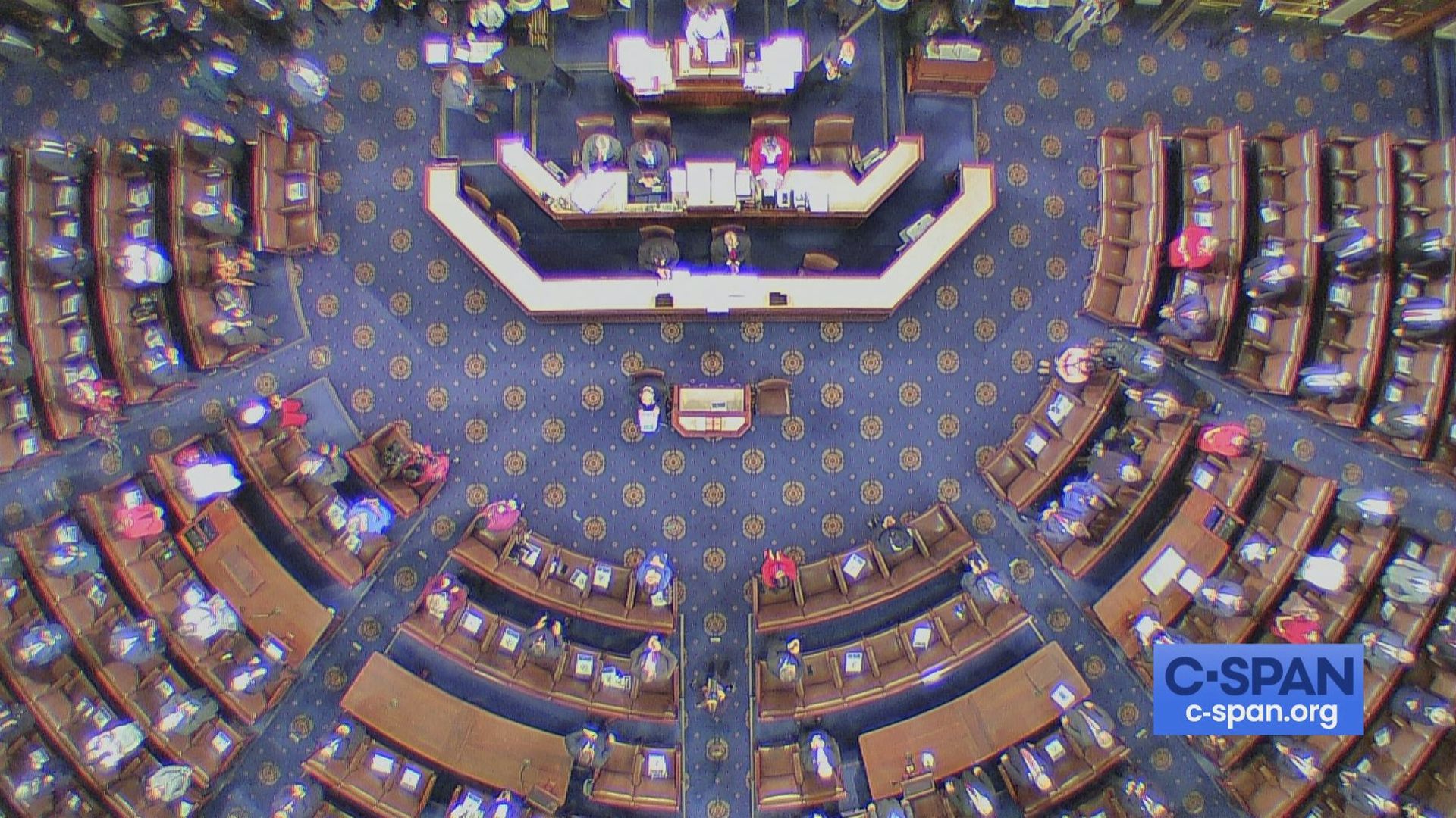 An overhead view shows the House chamber giving Nancy Pelosi a standing ovation after her re-election as speaker.