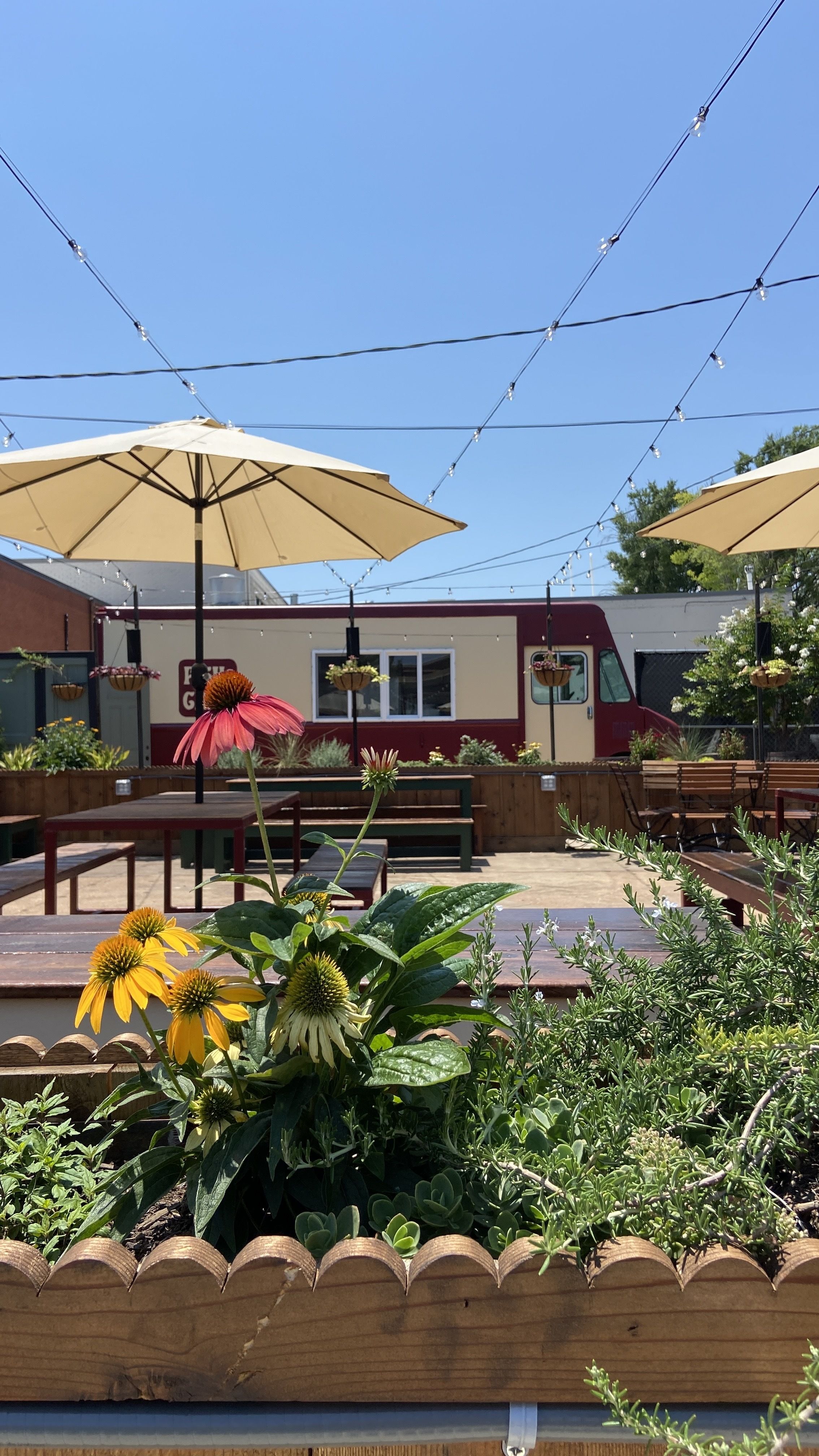 Tyber Creek's patio with flowers and food truck. 