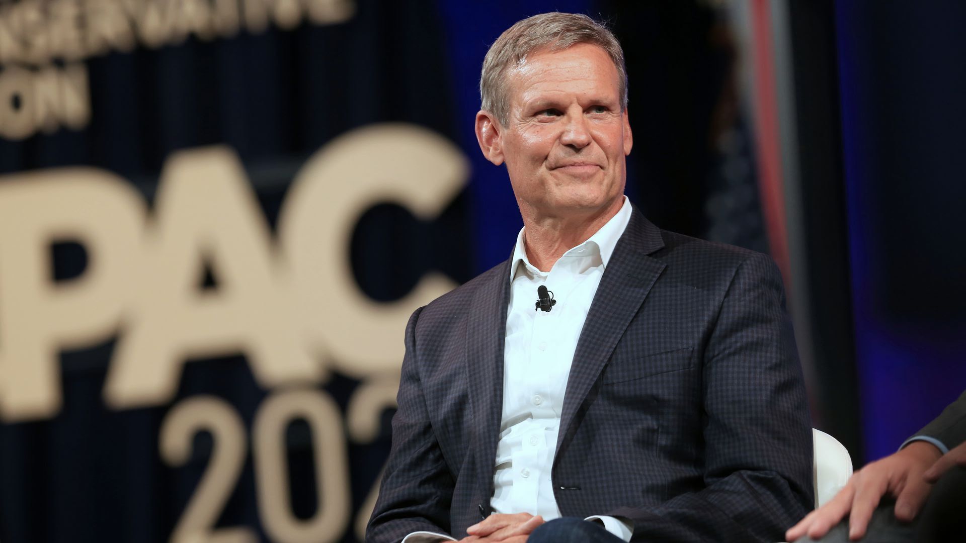 Gov. Bill Lee at an event in July wearing a black suit jacket and no tie 